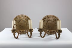 A pair of Arts and Crafts brass wall lights with Galleons in sail.