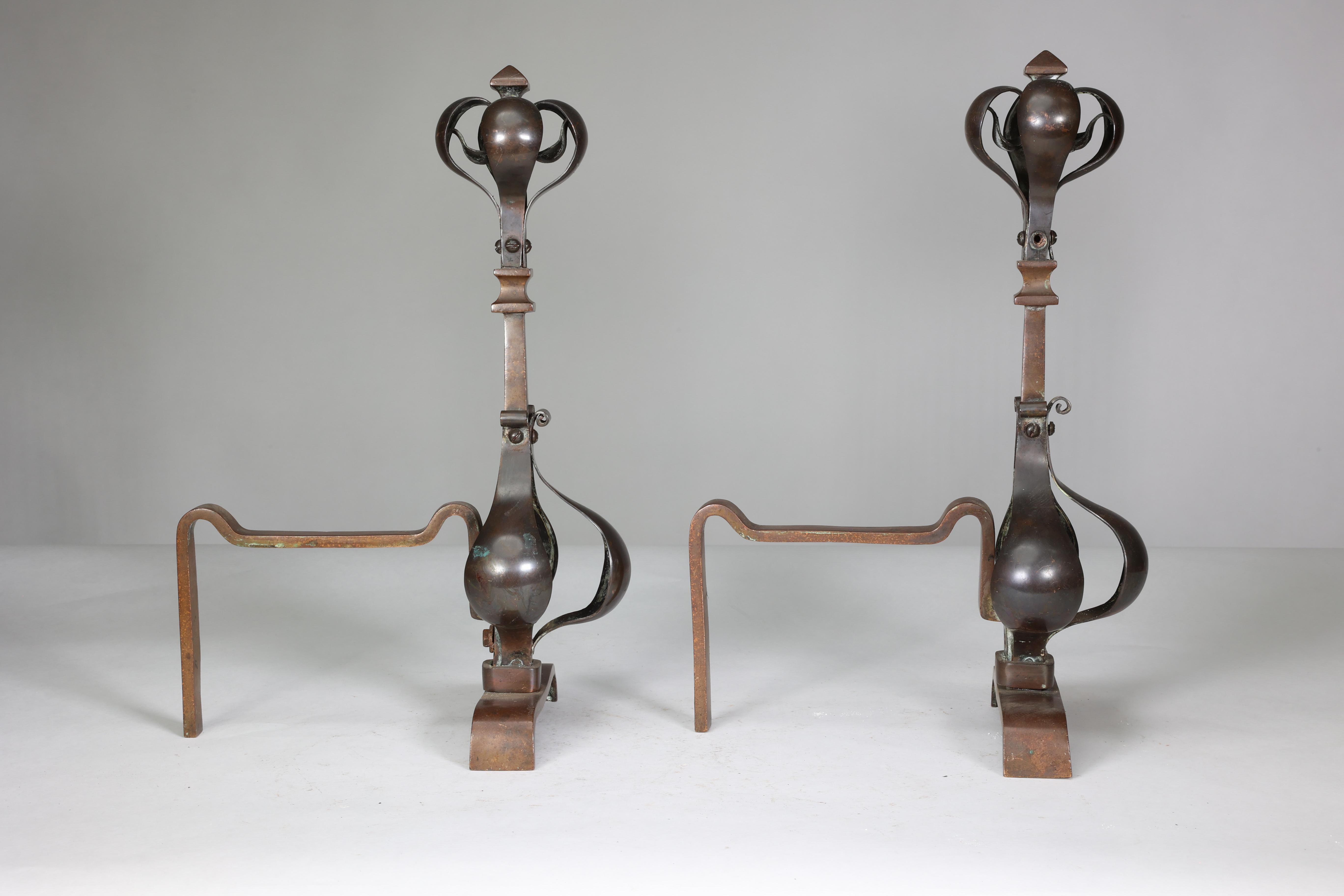 A pair of Arts and Crafts copper and bronze fire dogs with pyramid style finials For Sale 1
