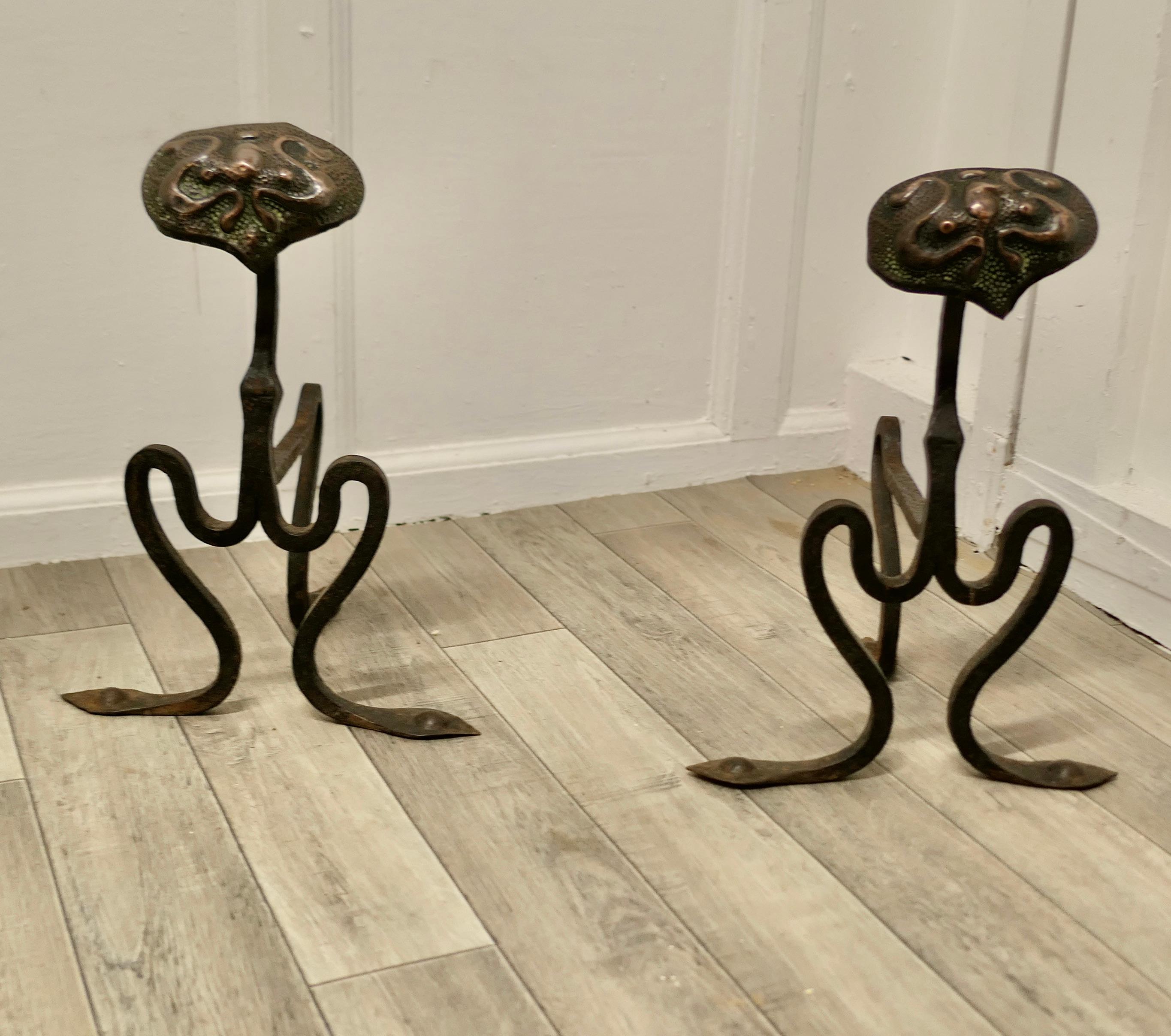 A pair of Arts and Crafts copper and iron andirons or fire dogs.


This very stylish pair of cast iron Andirons with a large hand beaten copper medallion, they are 15” high, 10” long and 11” wide across the front, they are in good antique