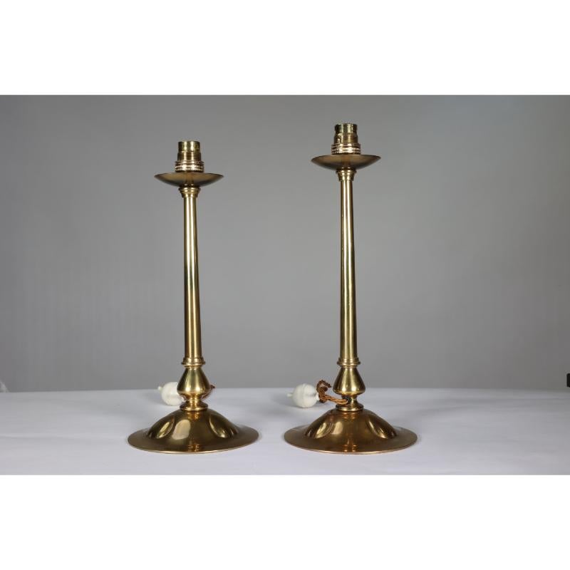 A pair of Arts and Crafts copper table lamps with three repousse hearts to each circular base. Professionally re-wired with period style switches and period style cables.

