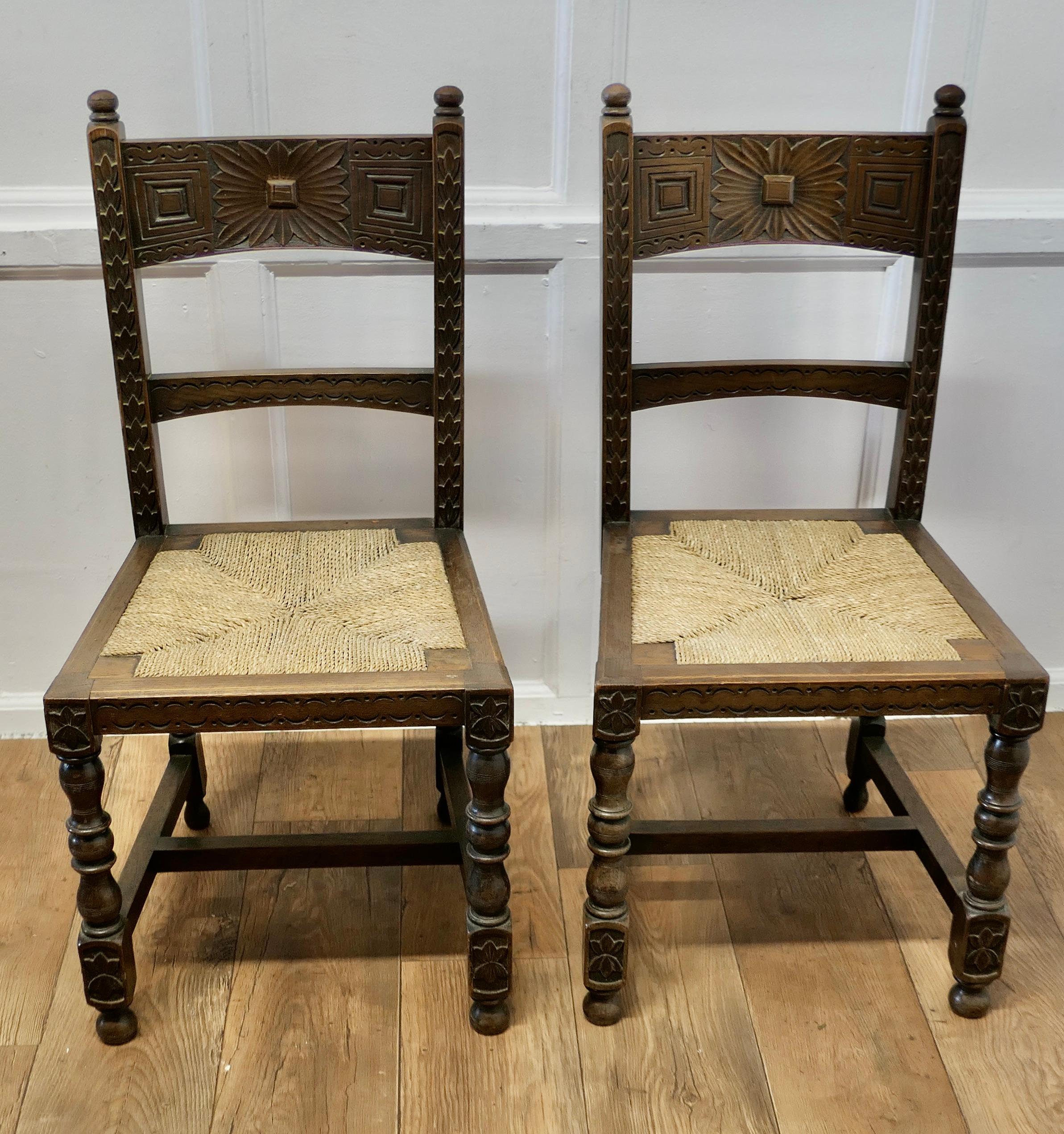 Gothic Revival A Pair of Arts and Crafts Gothic Carved Oak Hall Chairs  