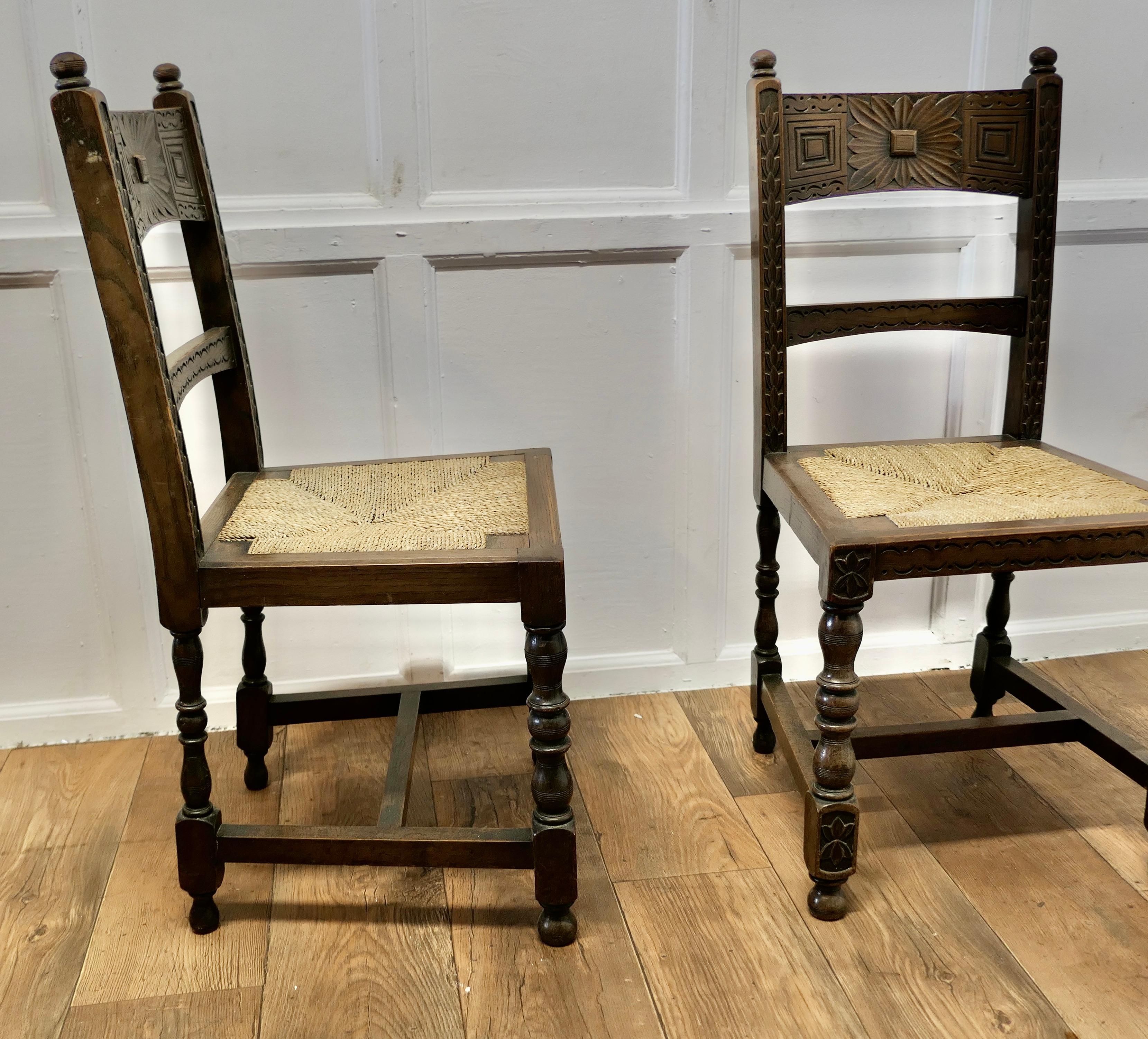 Early 19th Century A Pair of Arts and Crafts Gothic Carved Oak Hall Chairs  