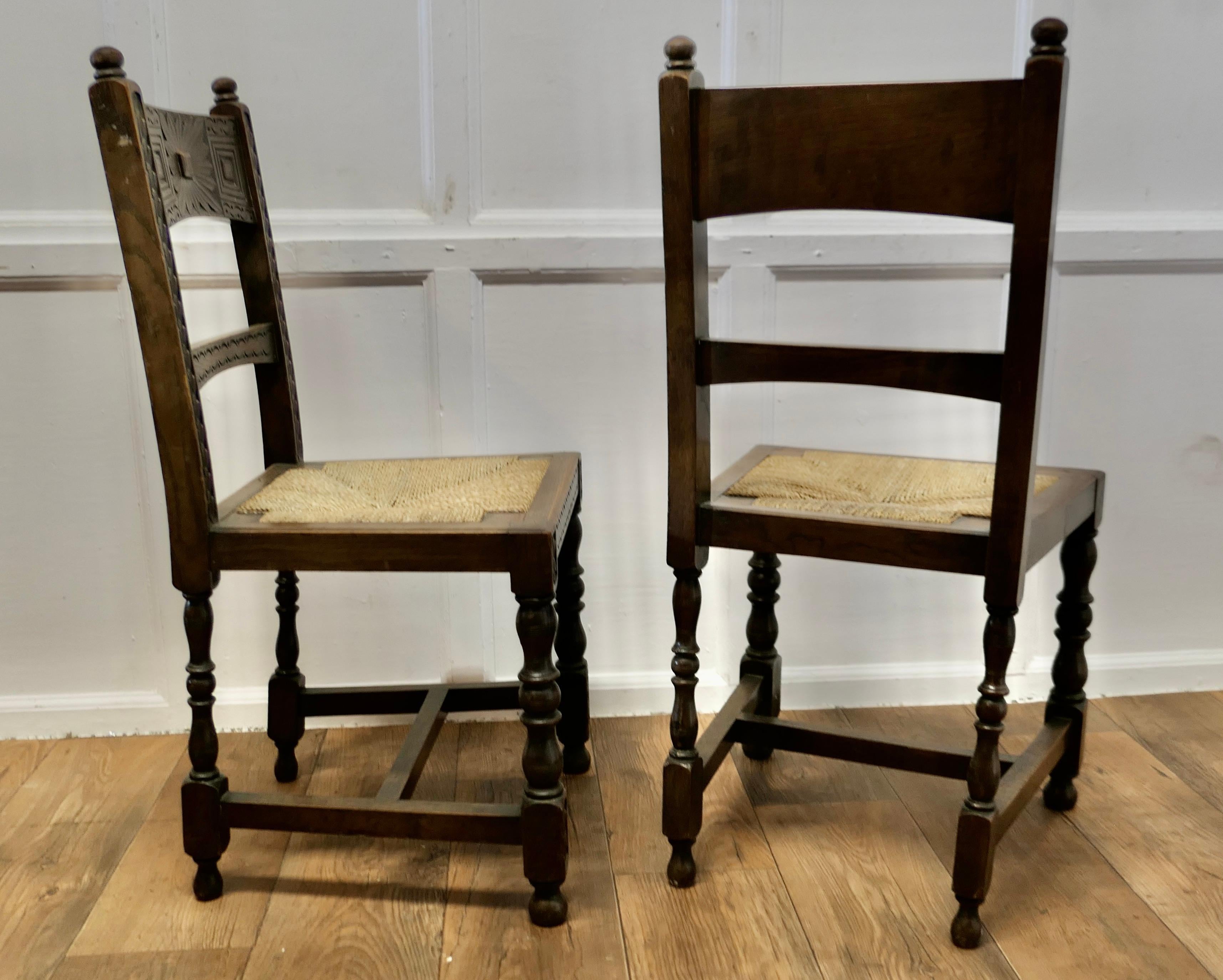 A Pair of Arts and Crafts Gothic Carved Oak Hall Chairs   1