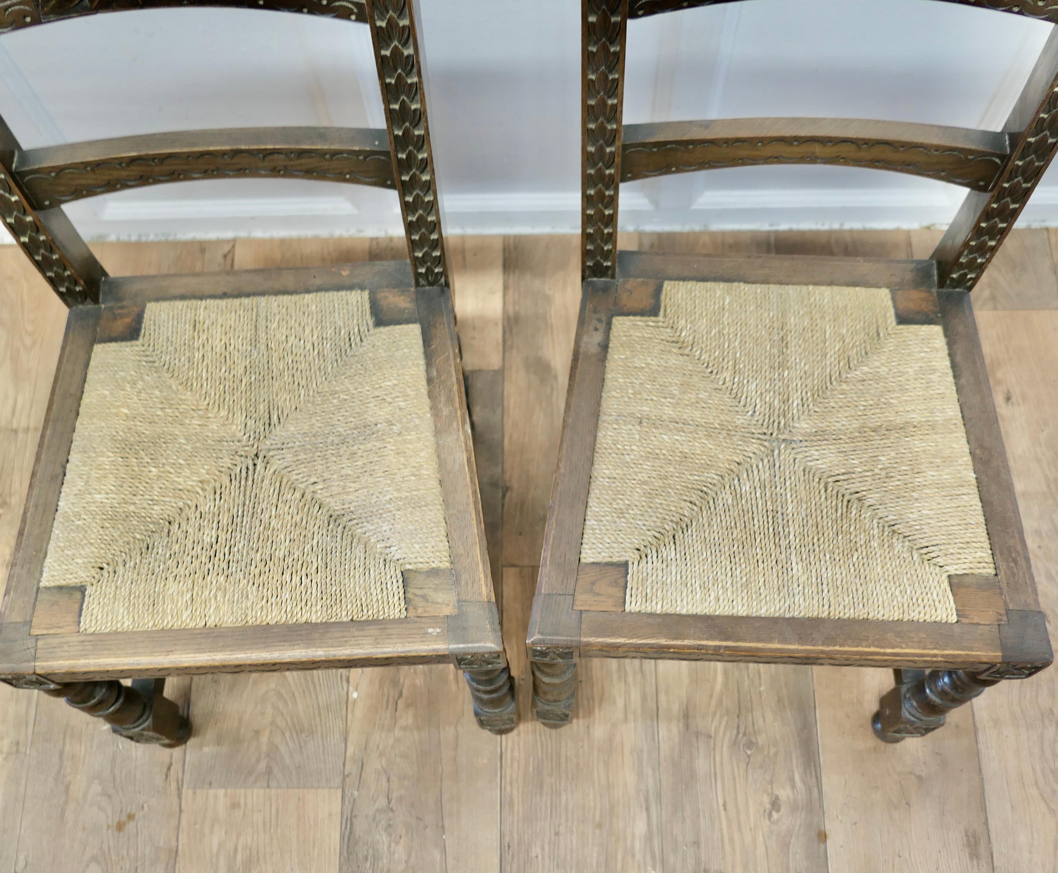 A Pair of Arts and Crafts Gothic Carved Oak Hall Chairs   2