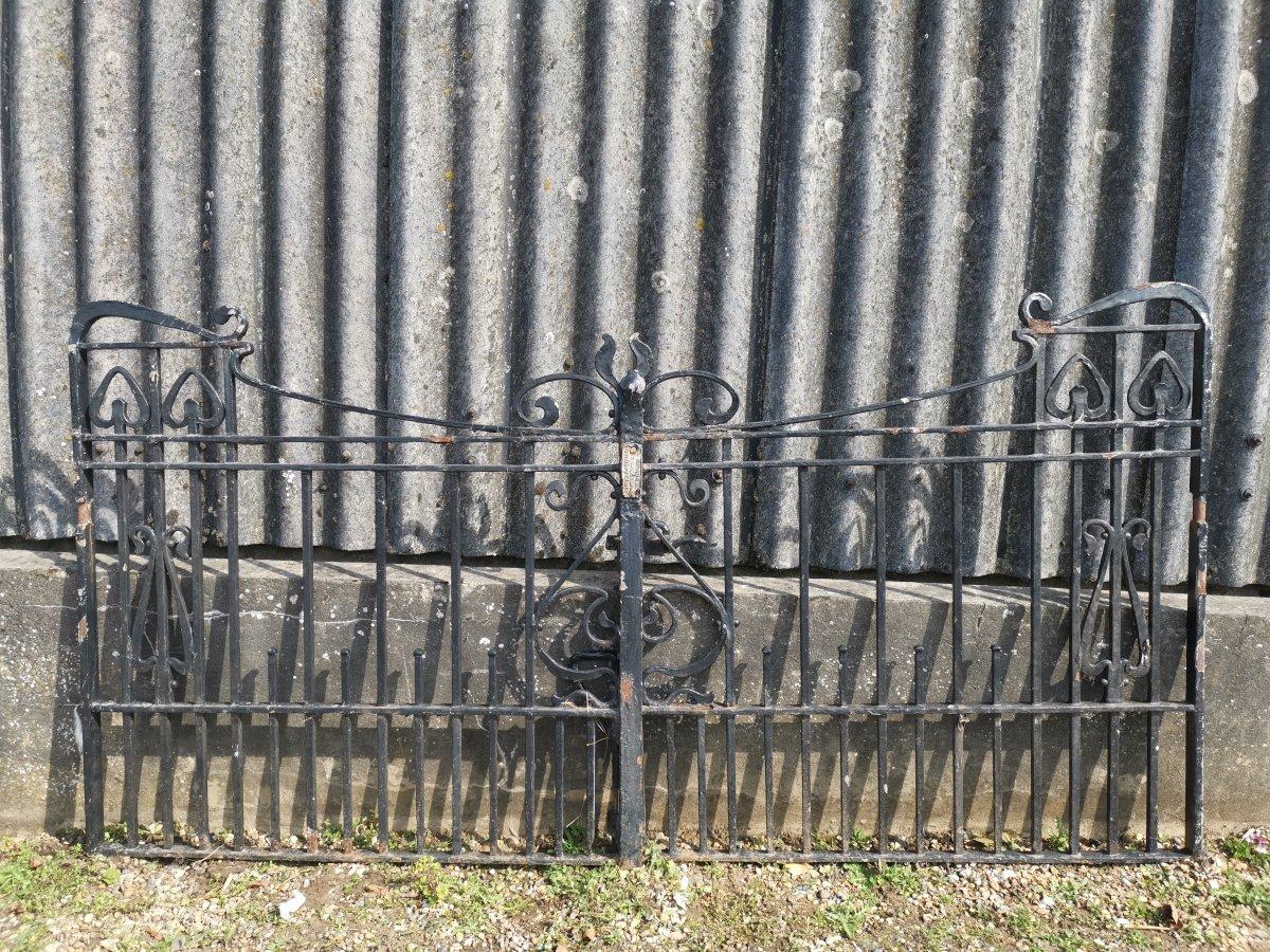 A rare pair of Arts & Crafts Master Craftsmans hand forged gates with sweeping top rails and hand formed whiplash tops pulled over and shaped to meet the ends of the central main scroll details. Retaining all of the original handles and bolts.
Made