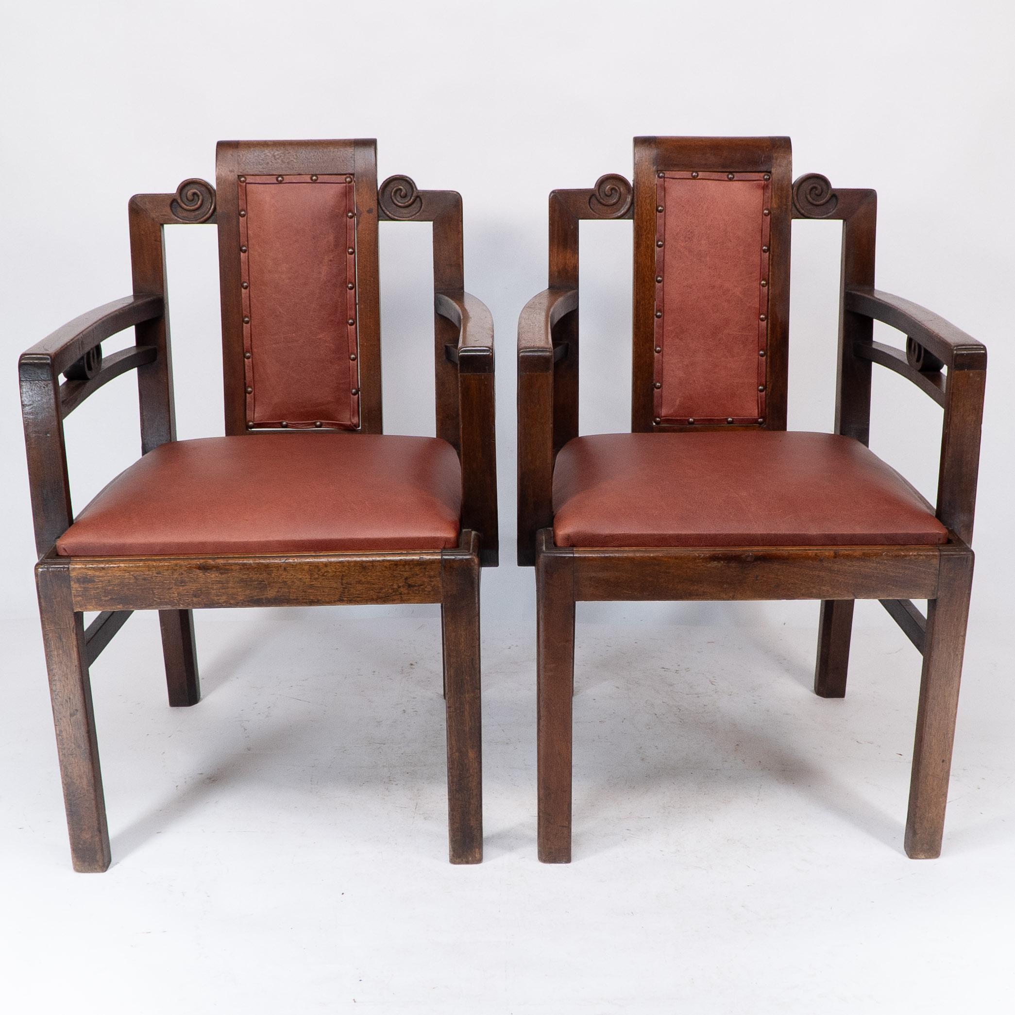 Sir Frank Brangwyn (attributed,) a pair of mahogany armchairs, in the Chinese style with professionally re-upholstered leather padded back and drop-in seat. 
These chairs share stylistic qualities with the famous armchairs he designed for the Salle