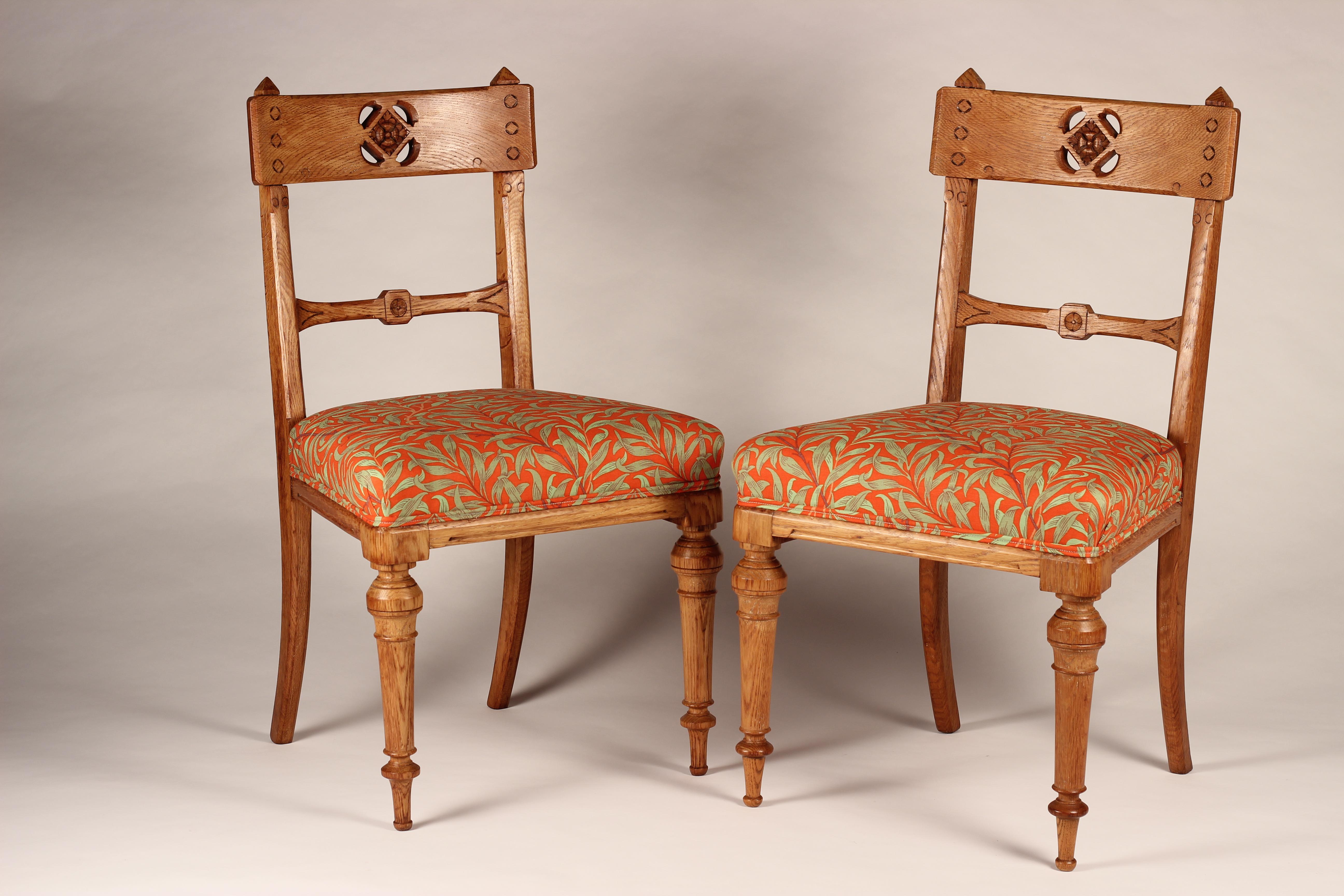 A Pair of Arts & Crafts Oak, back pierced hall chairs with re upholstered in Willow Bough Tomato Olive by Morris & Co from the Queen Square fabrics by Ben Pentreath.

Fabric details:
Product Type Print
Care Do Not Wash Warm Iron Dry Cleanable Do