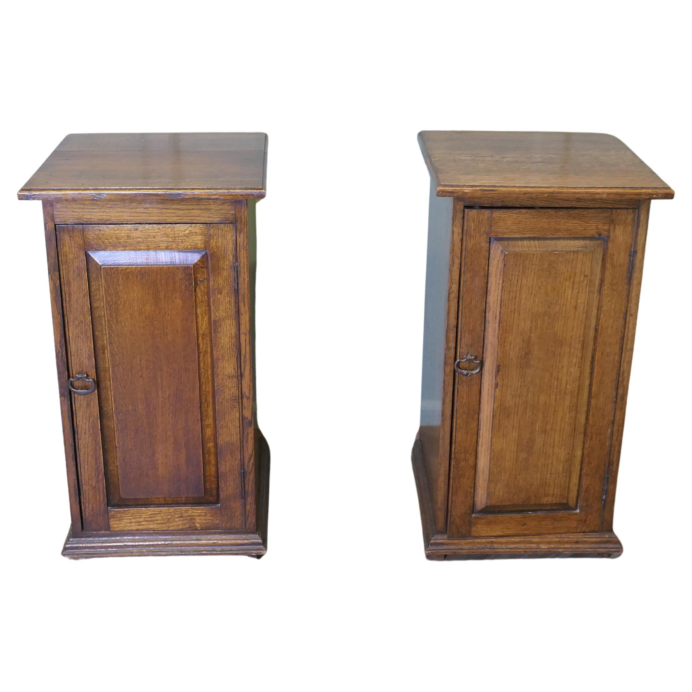 A Pair of Arts and Crafts Oak Bedside Cupboards