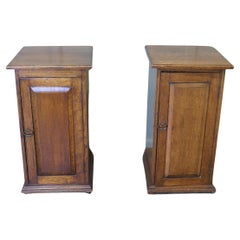 A Pair of Arts and Crafts Oak Bedside Cupboards