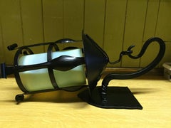 A Pair of Arts & Crafts Black Enamelled Vaseline/Uranium Hanging Wall Lanterns