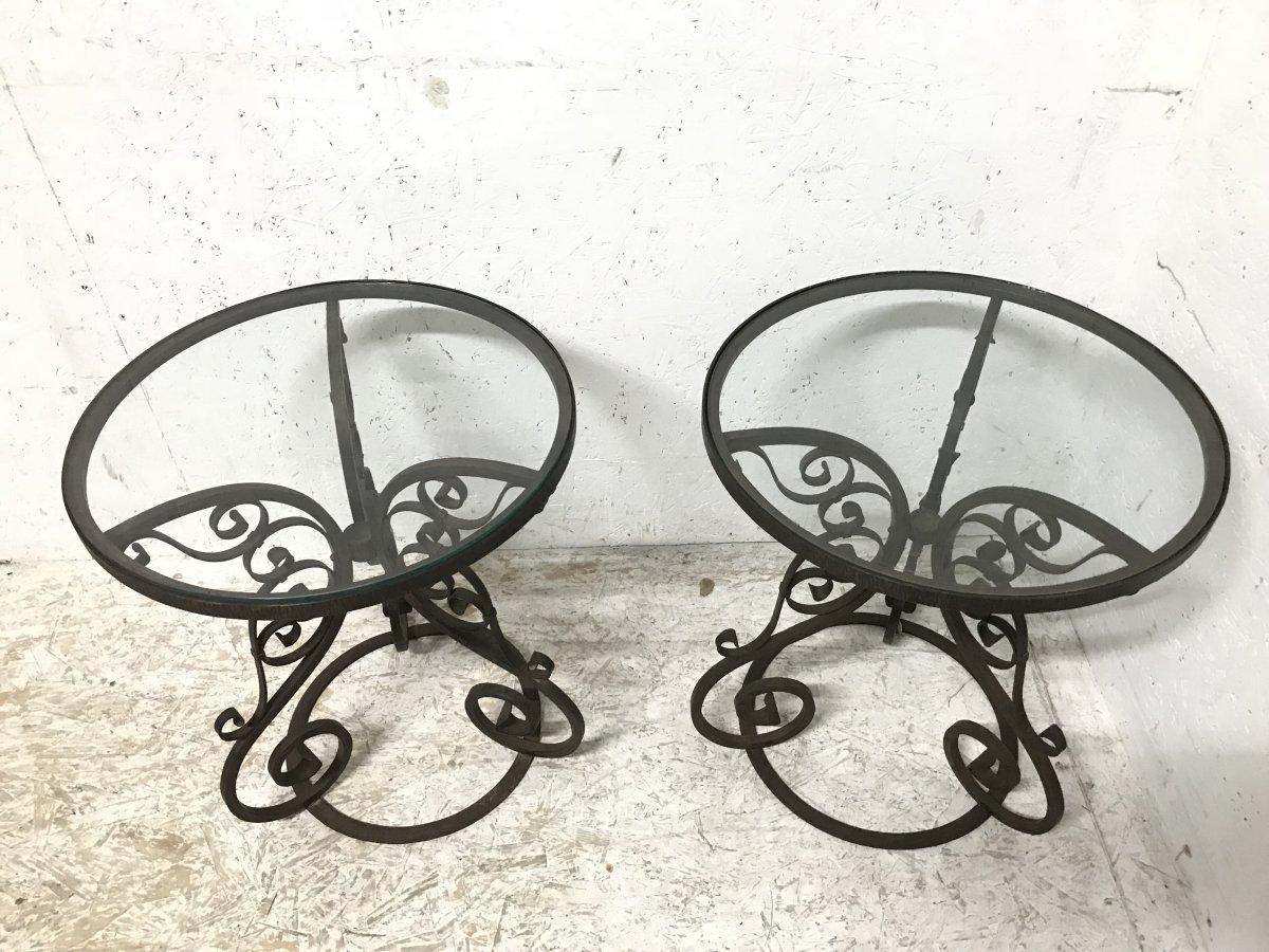 A sturdy pair of Arts & Crafts circular side tables with hand formed, wrought iron scroll work details and removable glass tops.
 