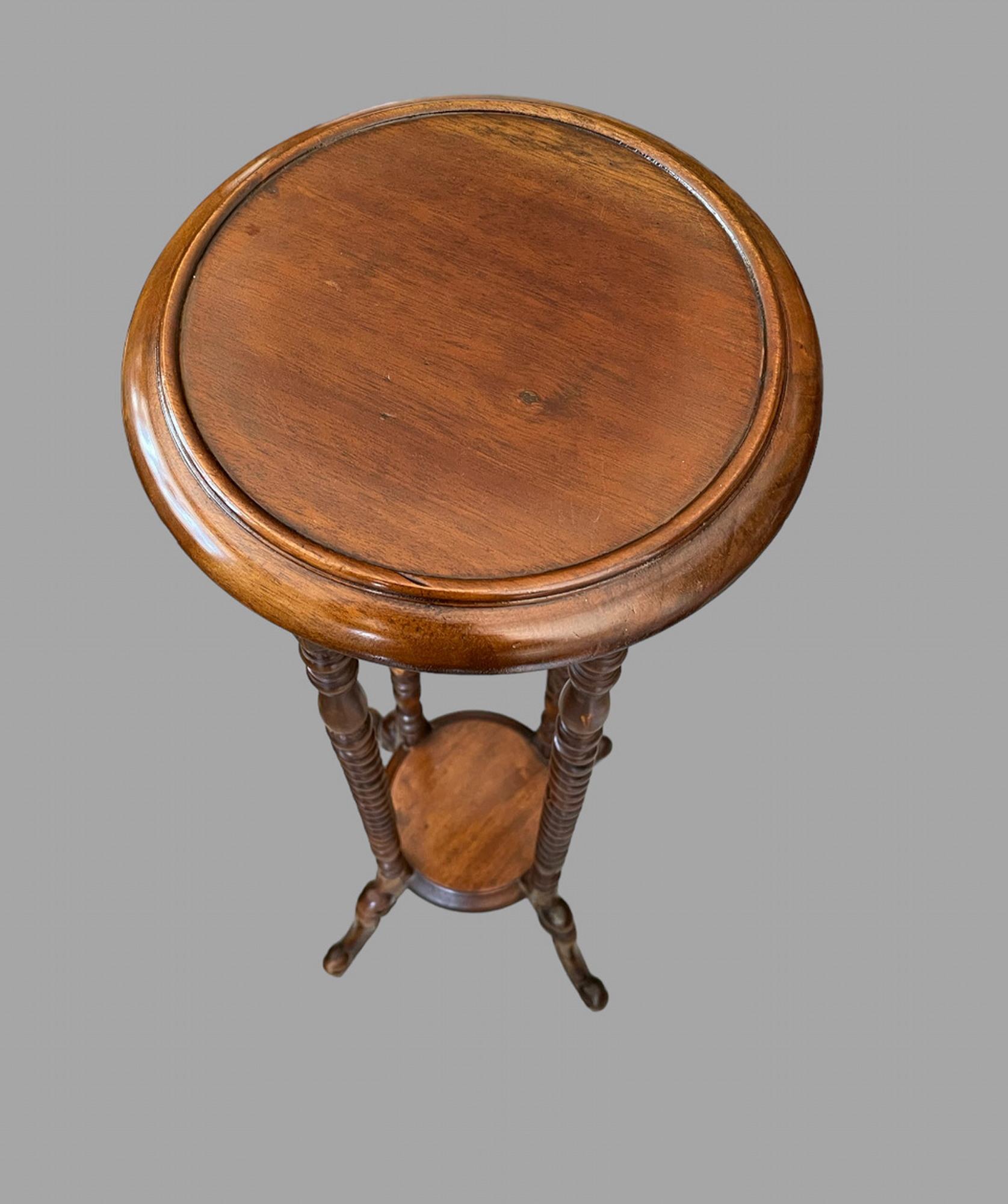 A Pair of Hand Carved English Mahogany Torchieres dating from late Georgian period. Tapered post mounted on cabriole legs the post turned with rings and dual pitched barley twists. Solid and ideal for many purposes.