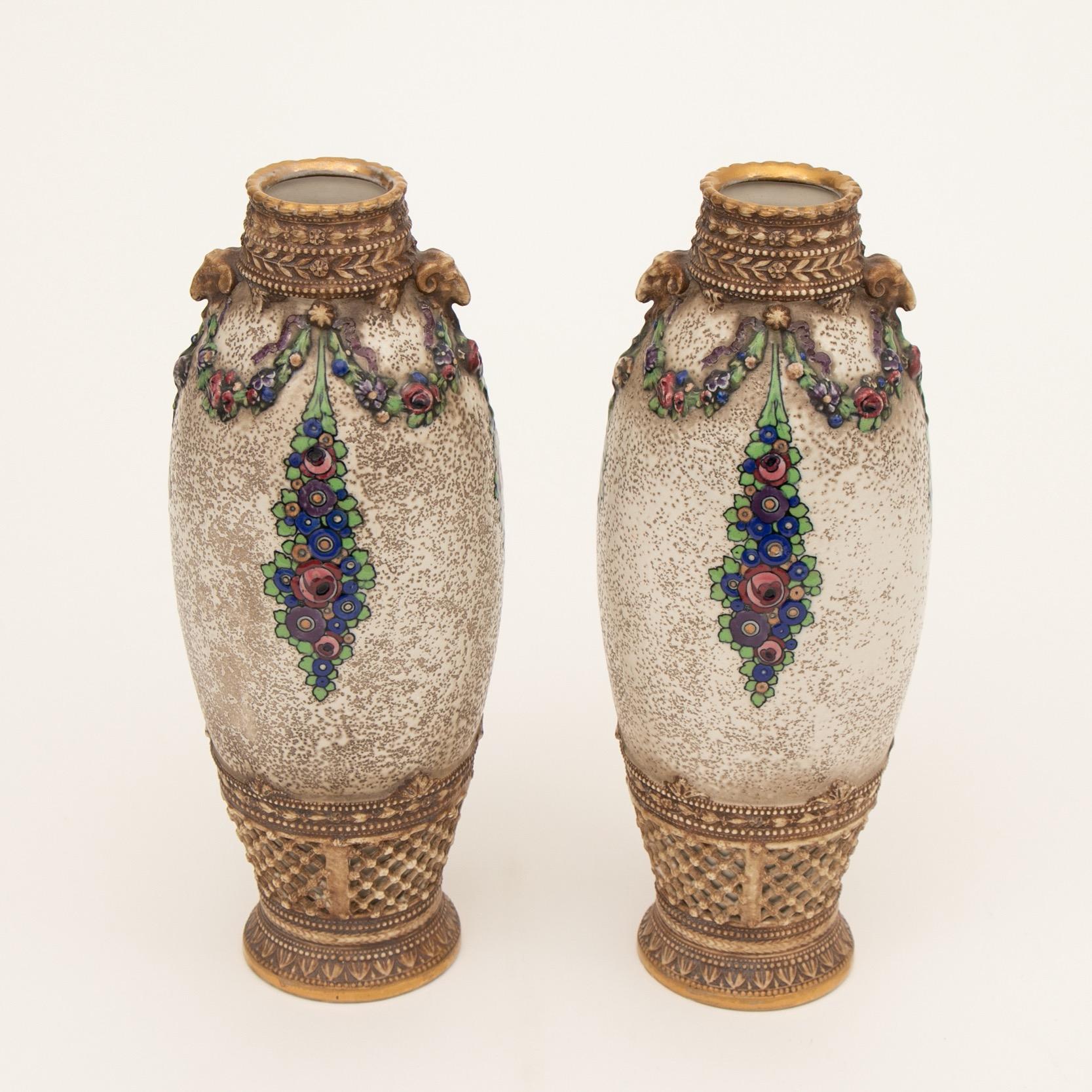 A superb pair of secessionist design vases produced by The Alexandra Porcelain Works. Turn Austria. Royal Vienna.
Designed by Paul Dachsel for Ernst Wahliss.
Beautifully decorated with two rams heads between floral embossed flower swags and