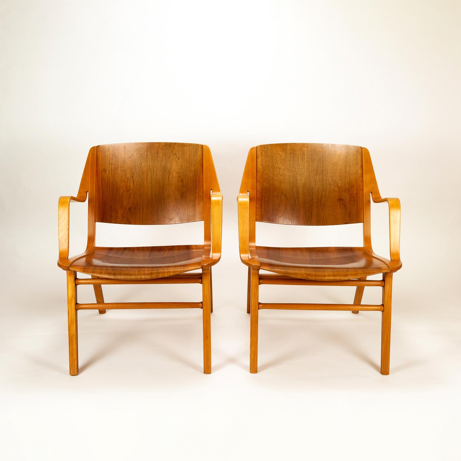 A pair of midcentury AX chairs in moulded and laminated teak and beech. Designed in 1947 by Peter Hvidt and Orla Mølgaard-Nielsen and manufactured by Fritz Hansen, Denmark, 1950s. Excellent vintage condition. Gently restored.