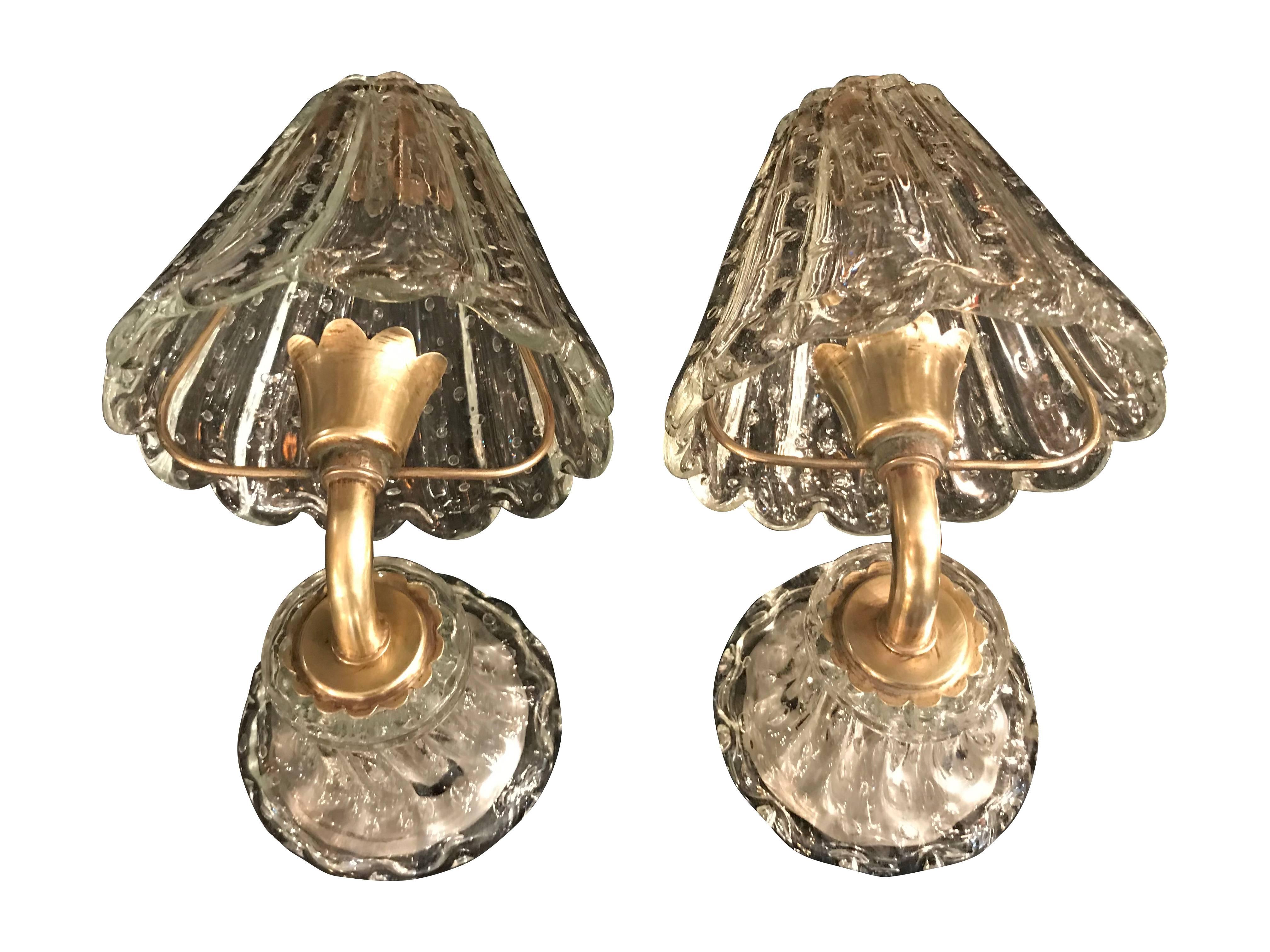 A pair of Barovier and Tosa clear, bullicante glass Murano wall sconces with a glass wall bracket supporting a brass frame, that supports the glass shade over the brass fitting. With a single bulb fitting, rewired and PAT tested.