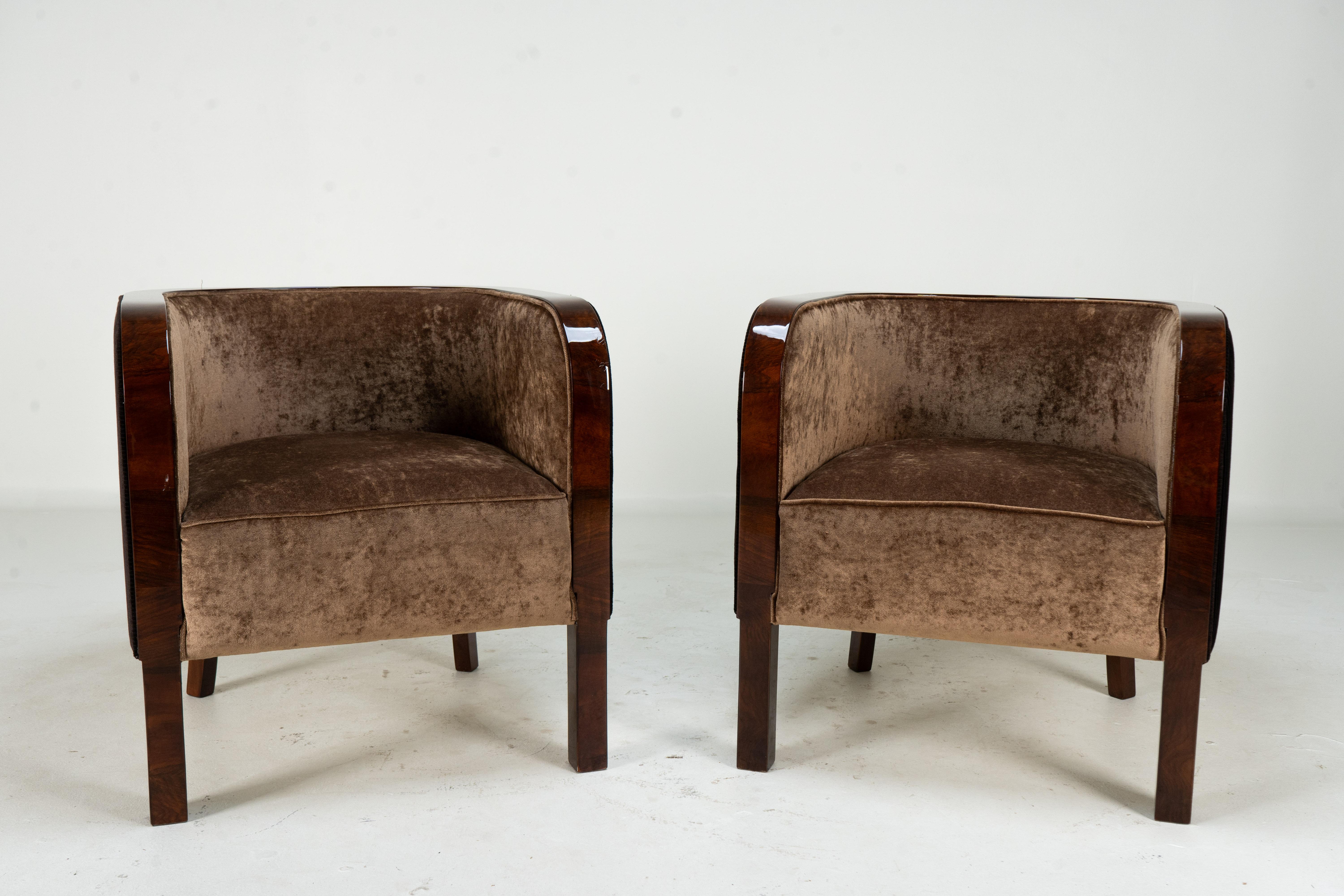These petite Hungarian curved-back chairs are handsomely designed with a rounded silhouette and a rich, dark wood frame. It features a low, enveloping back and plush upholstery in a soft, velvety fabric. Despite its compact scale, the chair offers