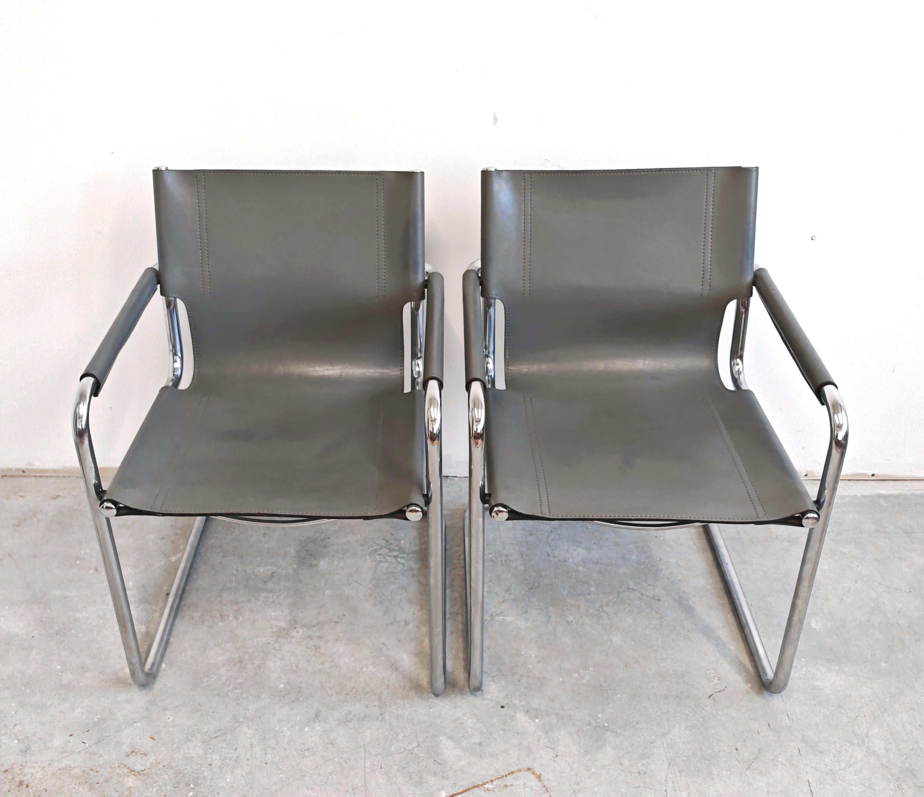 In this listing you will find the iconic Visitor's chairs designed by Mart Stam in 1920s and later manufactured by Matteo Grassi in the 1970s. The chairs feature tubular chrome plated steel frames and gray leather seats. Each chair has Matteo