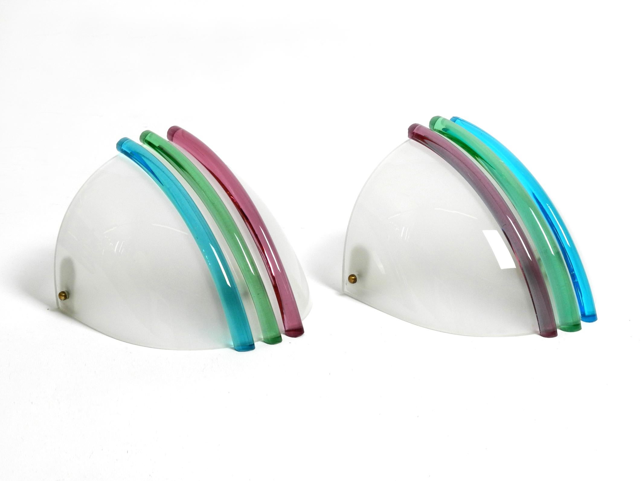 A pair of beautiful white Italian 1960's Murano glass wall lamps.
Great design with 3 colorful curved glass rods each on the shades.
With original label on one lamp. Made in Italy.
The white shovel-shaped high-quality glasses are in mint