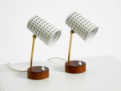 A pair of beautiful mid-century modern bedside lamps with perforated metal shade