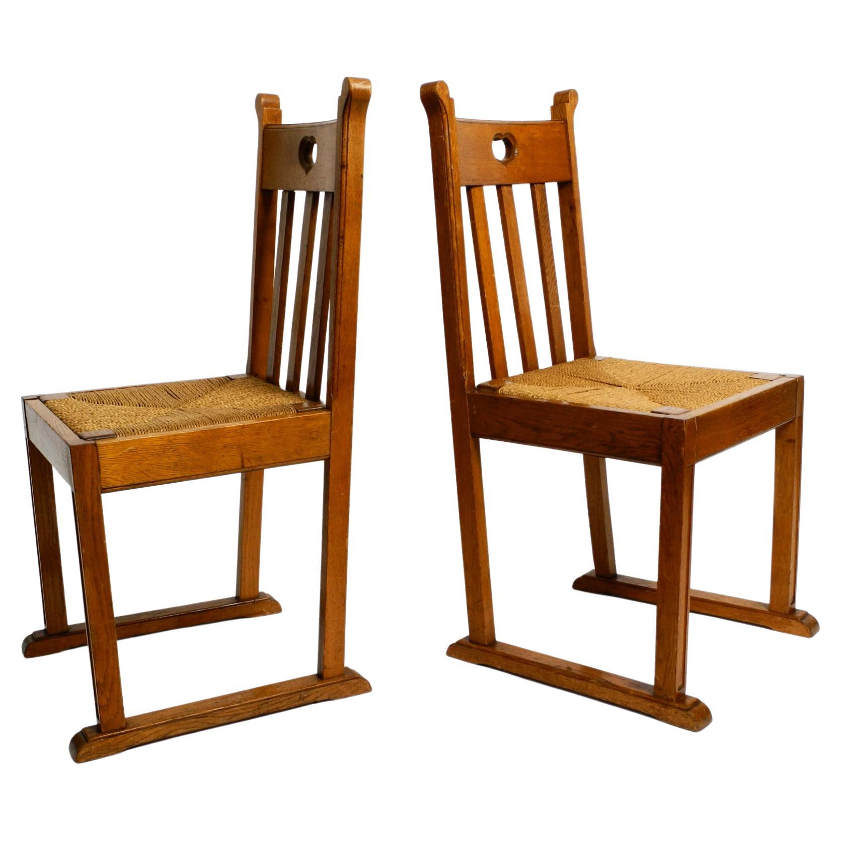 Pair of Beautiful Rare Mid Century Oak Chairs with Skid Feet and Wicker Seats For Sale