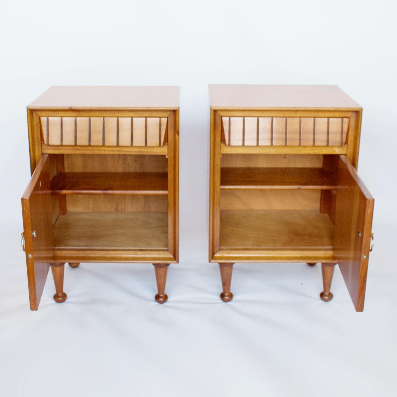 A pair of bedside cabinets by Heal's of London. Veneered satin birch with mahogany lined upper drawer and central cupboard. Stamped Heal's to inside of cupboard door. 

Dimensions: H 61cm W 41cm D 33cm 

Origin: English

Date: Circa, 1950


