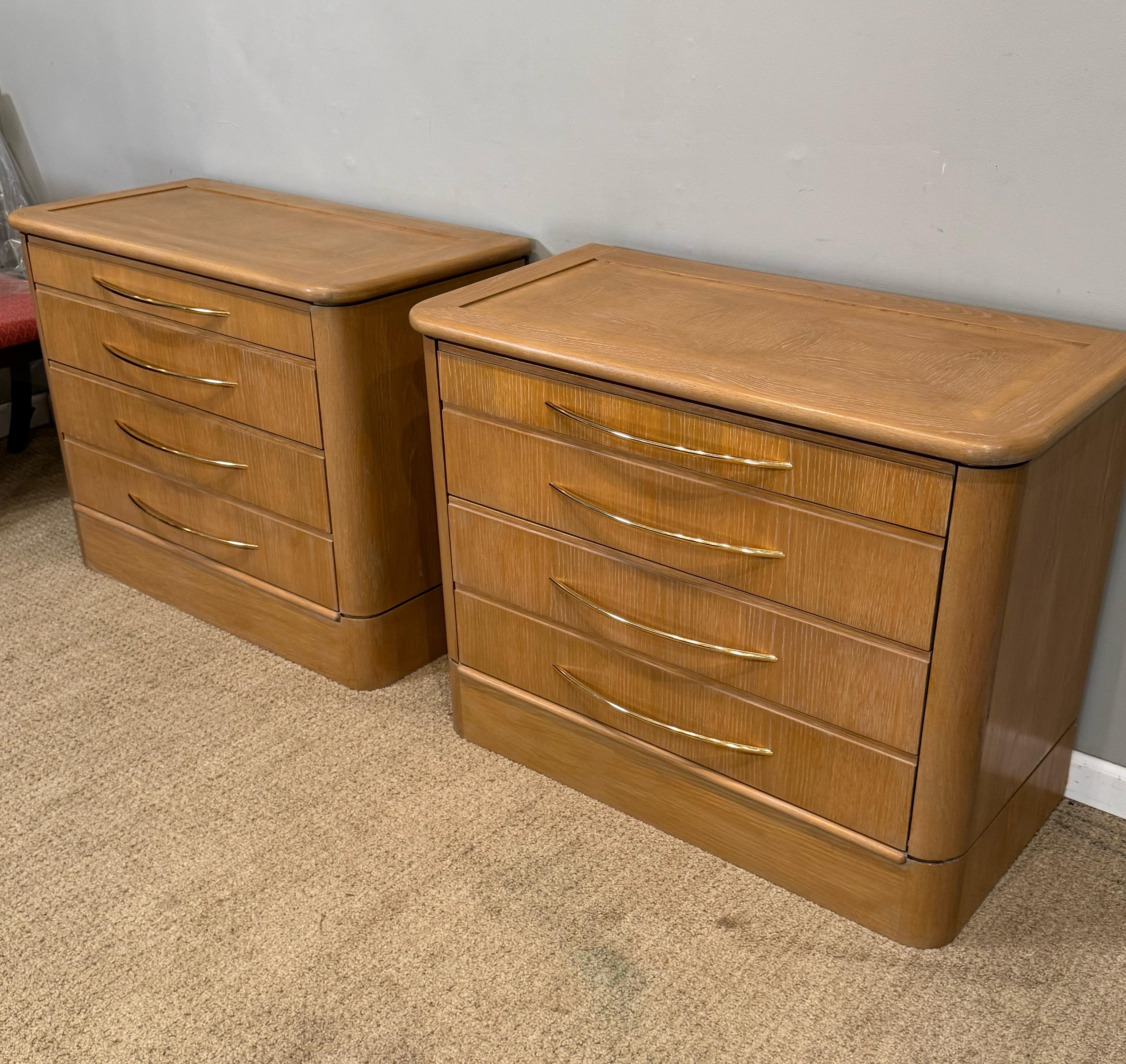 A Pair of Bedside Chests In a lightly Cerused 
Light oak finish. With Graduated sized drawers
And soft close drawer runners. Brass handles
Recently finished 