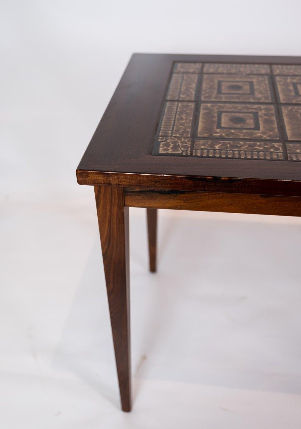 A pair of bedside tables in mahogany with brown tiles of Danish design from the 1960s. The tables are in great vintage condition.
 