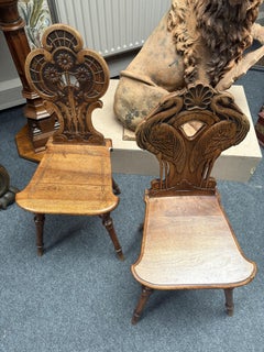 A pair of beech wood hall chairs Swiss or Italian circa 1890 beautifully carved