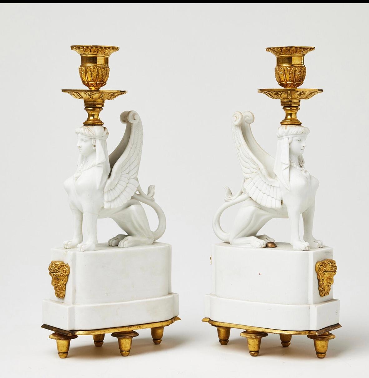 Rares pair of biscuit Sphynxes forming torches 
Adorned with gilded bronze bobèches and motifs, mounted on base with Louis XVI feet,
Variant of a pair of torches, attributed to Nast, ref. Sothebys sale
Variant of Wedgwood Sphynxes torchs 