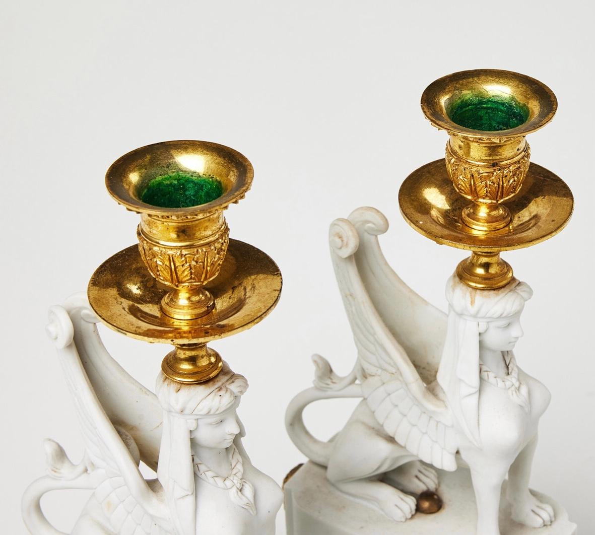 French A Pair of Bicuit  and Bronze Sphynxes Candelsticks , close to a Model att.Nast  For Sale