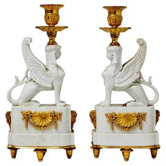 A Pair of Bicuit  and Bronze Sphynxes Candelsticks , close to a Model att.Nast 