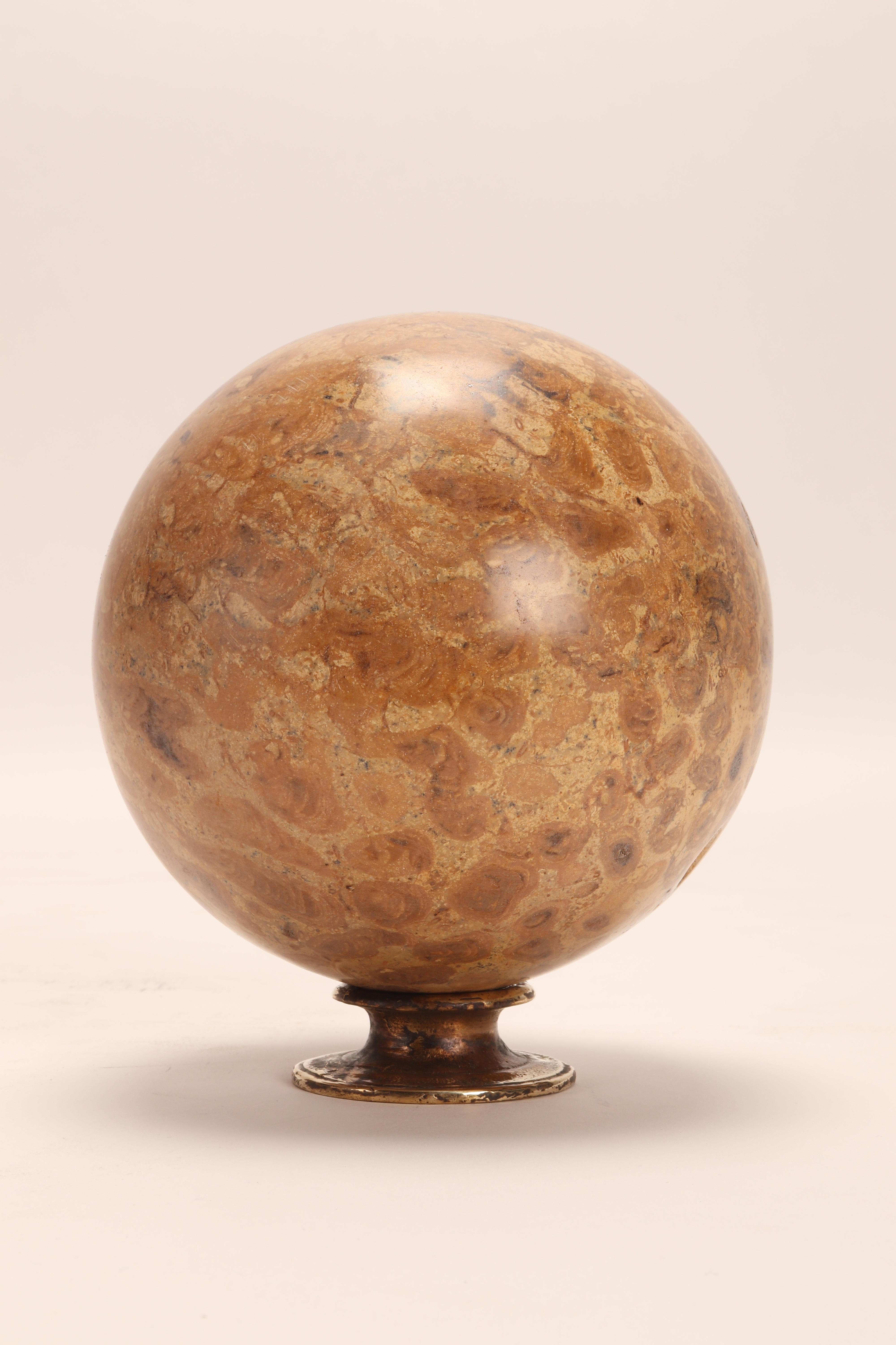 A pair of big fossil coral stone spheres, resting on a base, made of brass. Italy circa 1870.