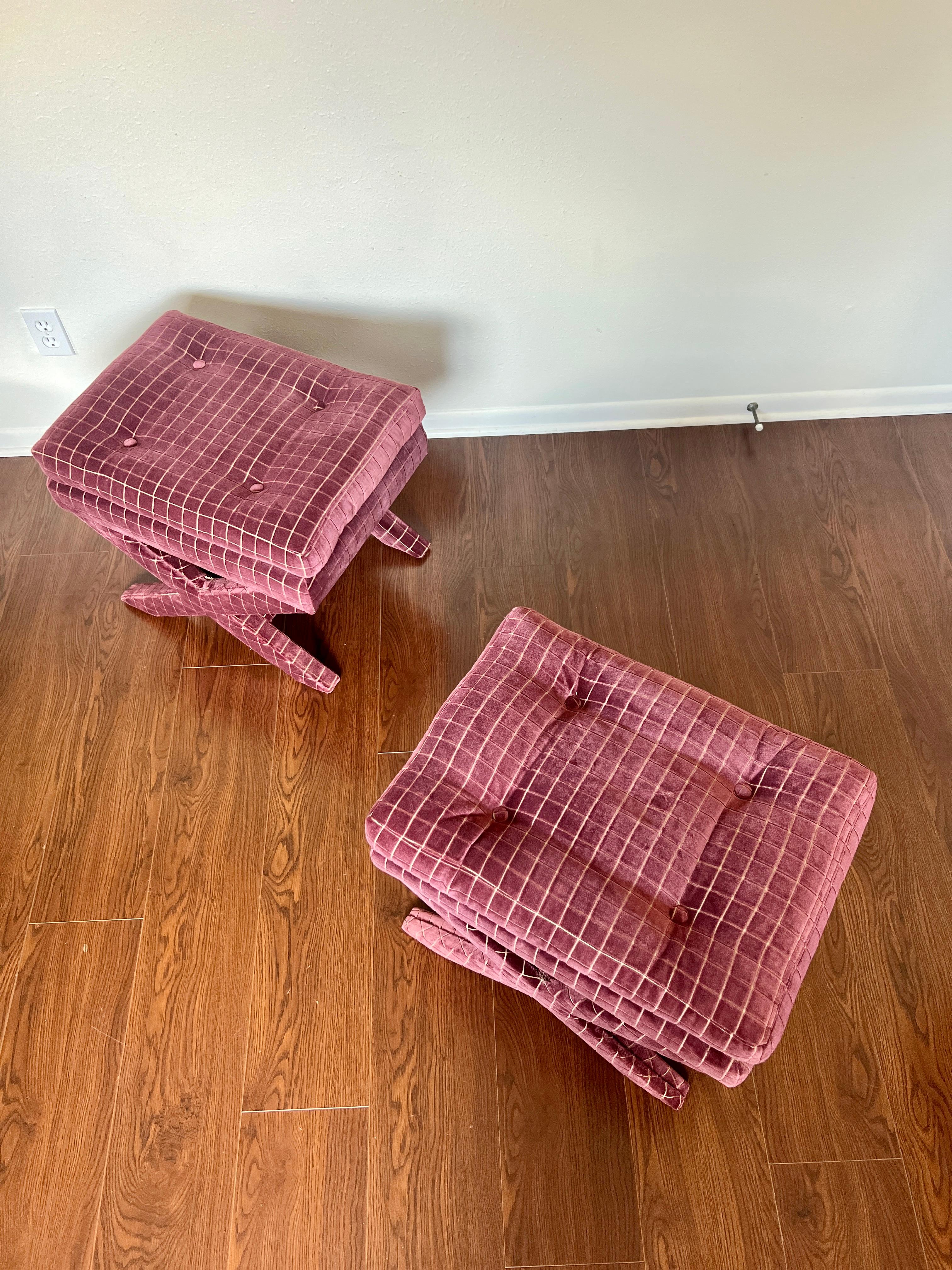 A pair of vintage X-base ottomans newly upholstered in GP & J Baker wine mauve velvet fabric in the style of Billy Baldwin. These stools feature fully upholstered X-form frames, button tufted seats, clean modernist lines, great style and form, circa