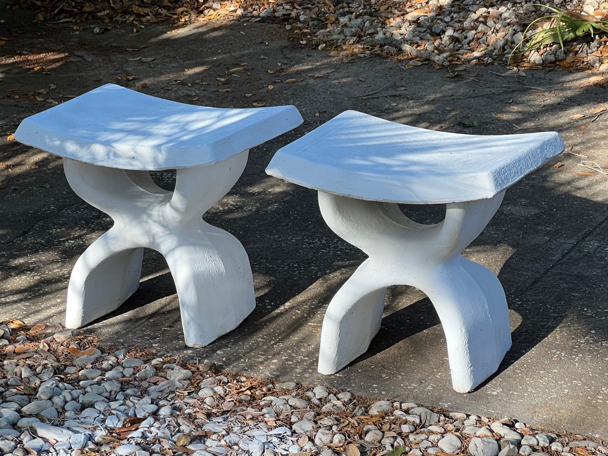 A pair of heavy (over 100 lbs each) cast concrete stools, signed Robinson, Florida, 1974. Unusual biomorphic design.