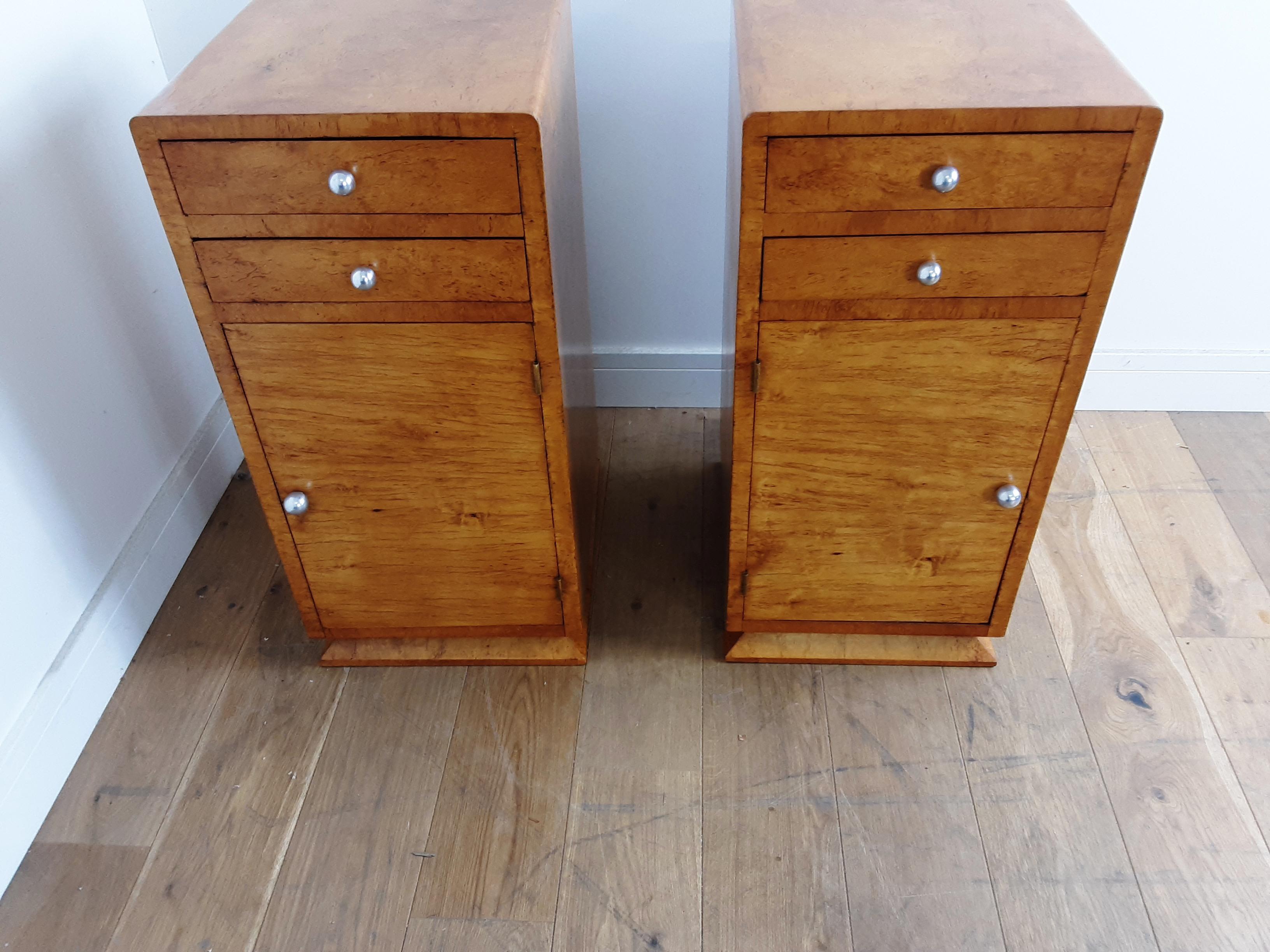 A pair of Art Deco bedside cabinets in bird's-eye maple.
Two drawers to the top and cupboard below with single shelf.
Chrome ball handles and drawer pulls.
Nice curved edges to the top and angle skirt to the base, nice decorative grain to the