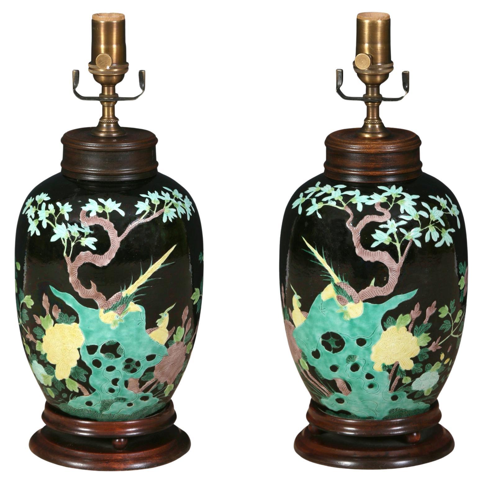 A Pair of Black Chinese Porcelain Lamps with Floral Design on Wood Base For Sale