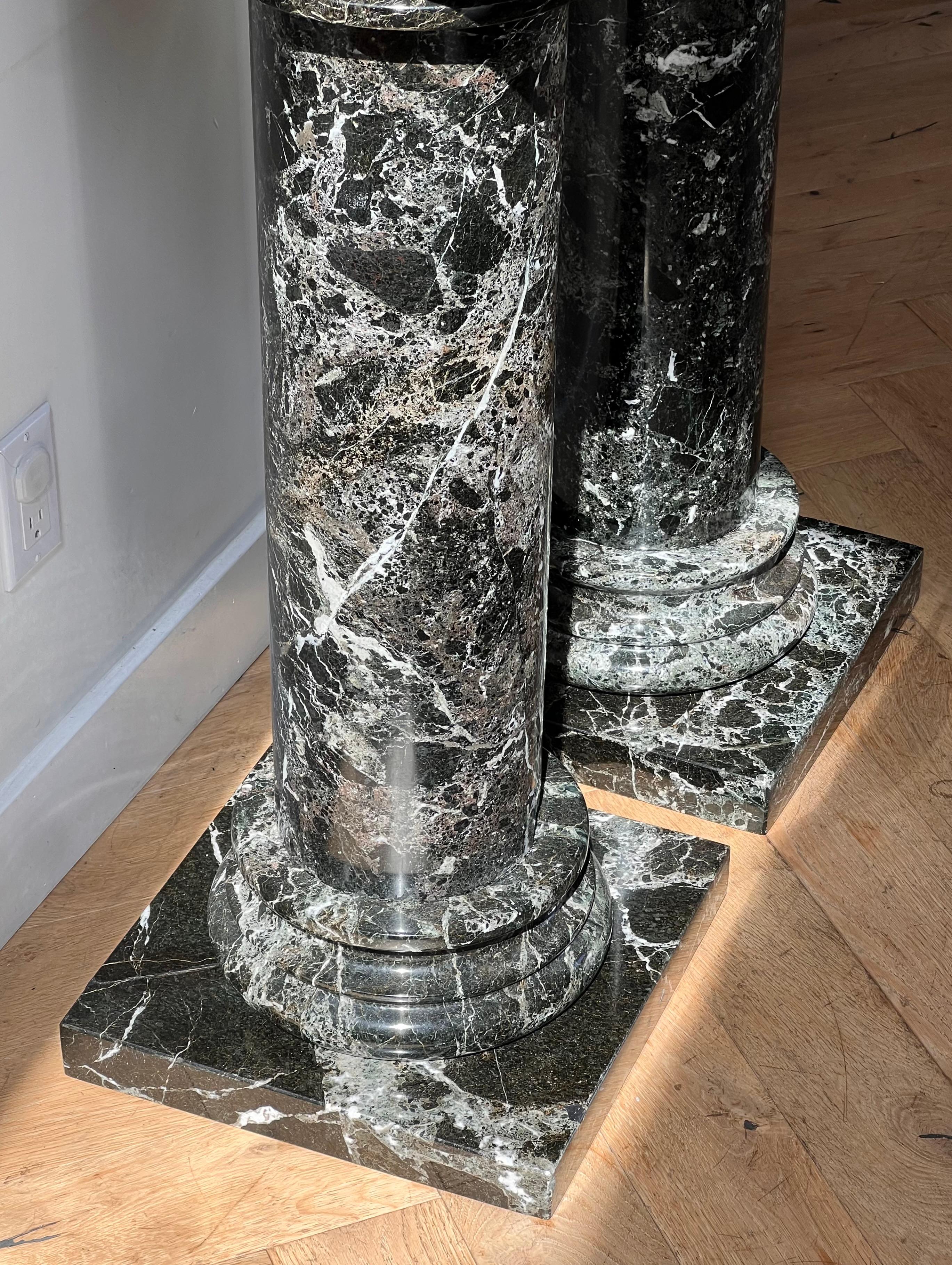 Marble A pair of black marble pedestal columns, late 20th century
