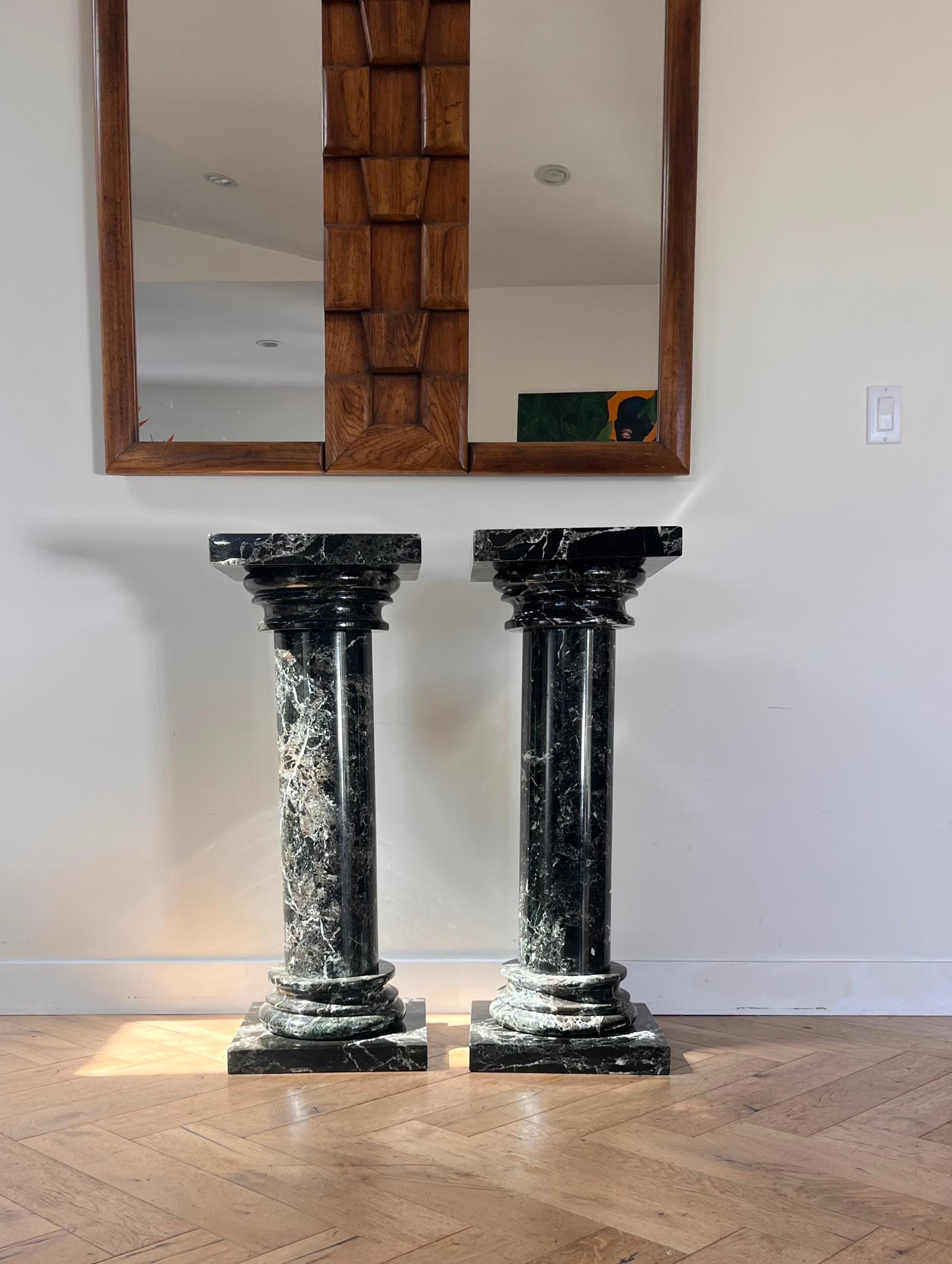 A pair of black marble pedestal columns, late 20th century 1