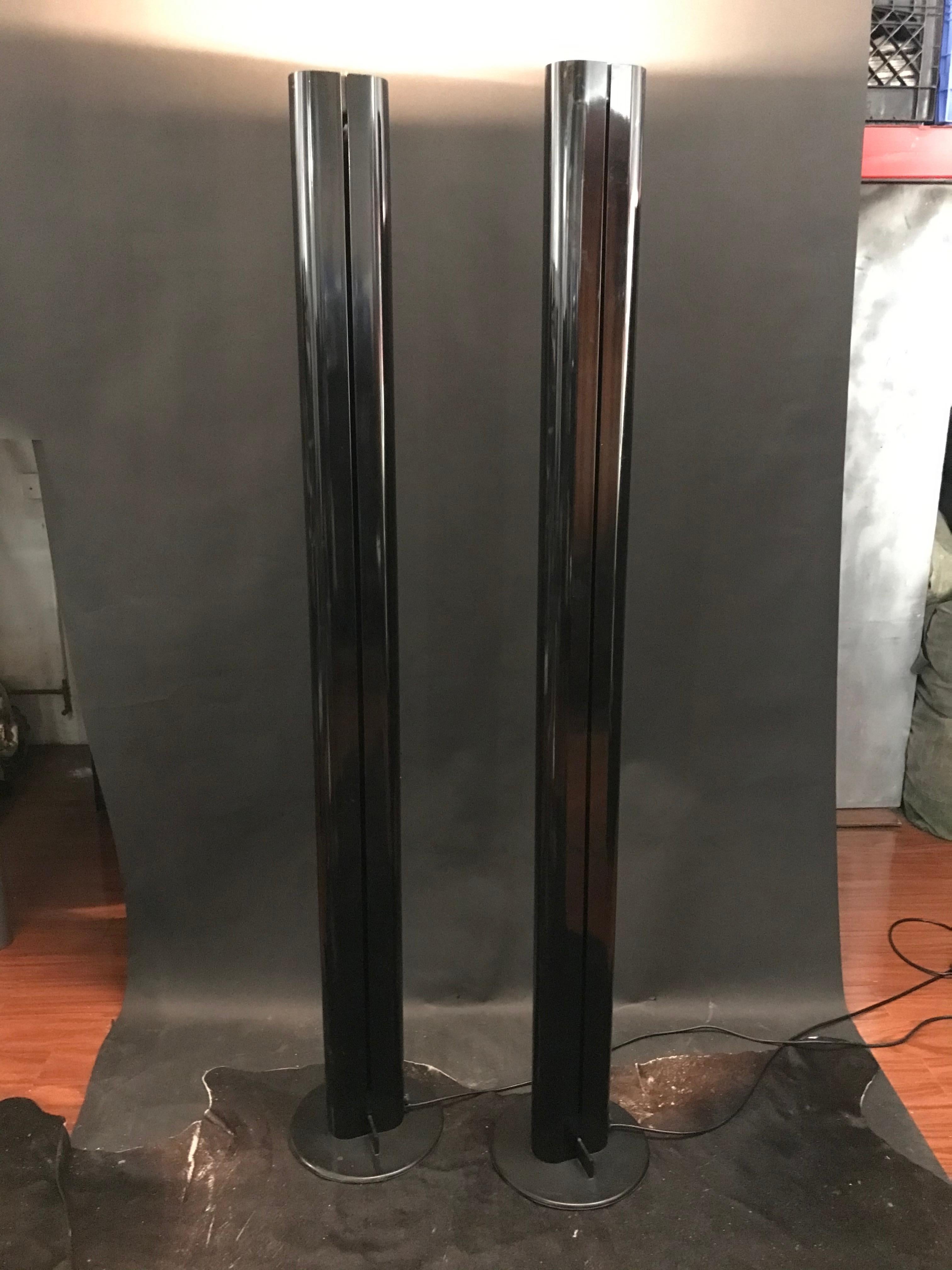 A pair of minimalist 1970’s black megaron lamps by Gianfranco Frattini for Artemide. Minimal wear to both and no severe damage or imperfections on the rubber bases. One lamp is missing the pin for its 100mm dimmer but is still cleanly movable and in