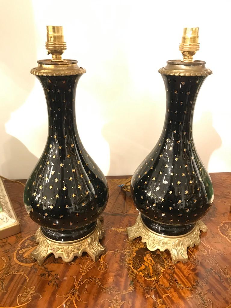 Hand-Crafted Pair of Black Porcelain Lamps on Ormolu Bases with Gold Star Detailing For Sale
