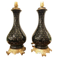 Antique Pair of Black Porcelain Lamps on Ormolu Bases with Gold Star Detailing