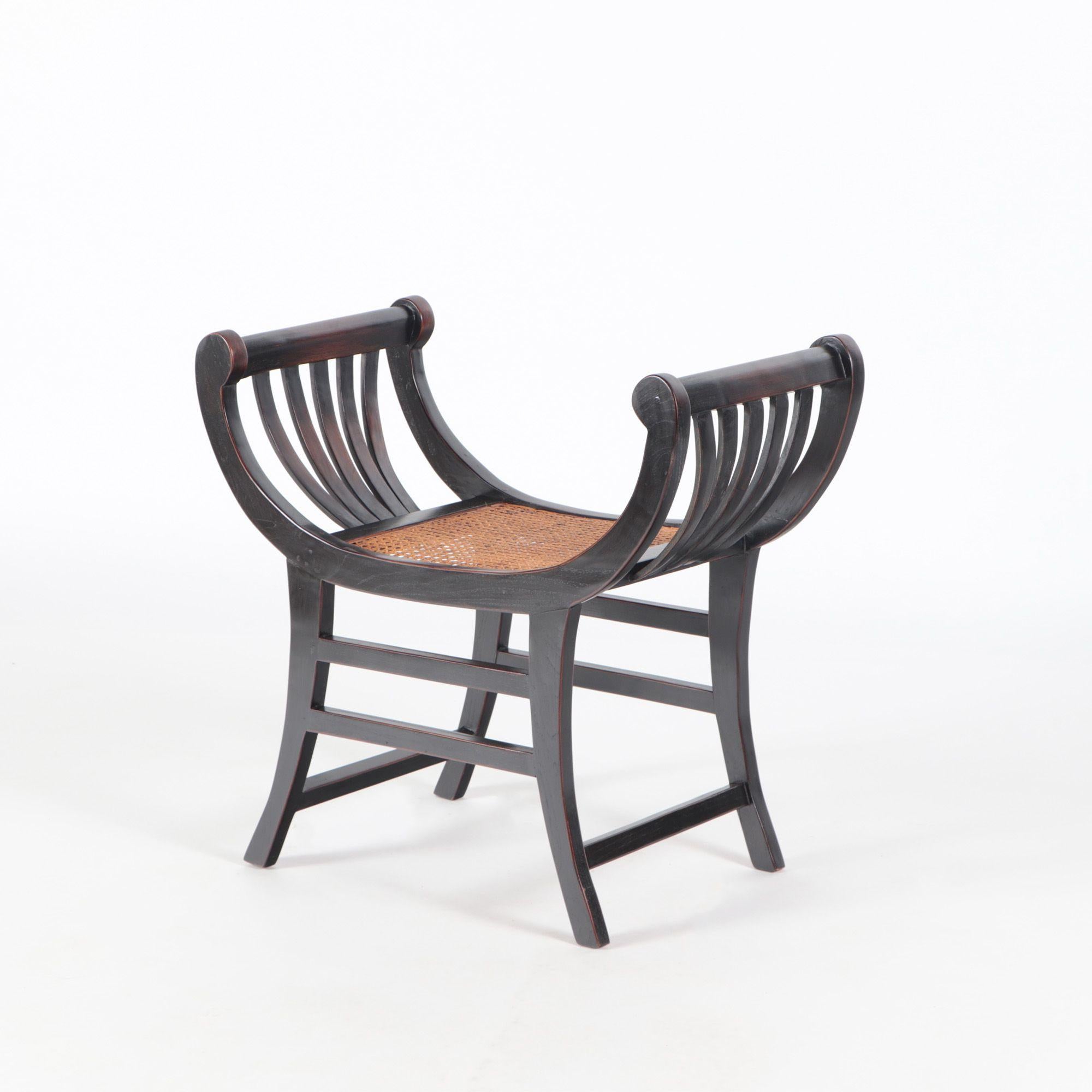 A pair of black teak rattan curved Sartika stools benches from Indonesia.