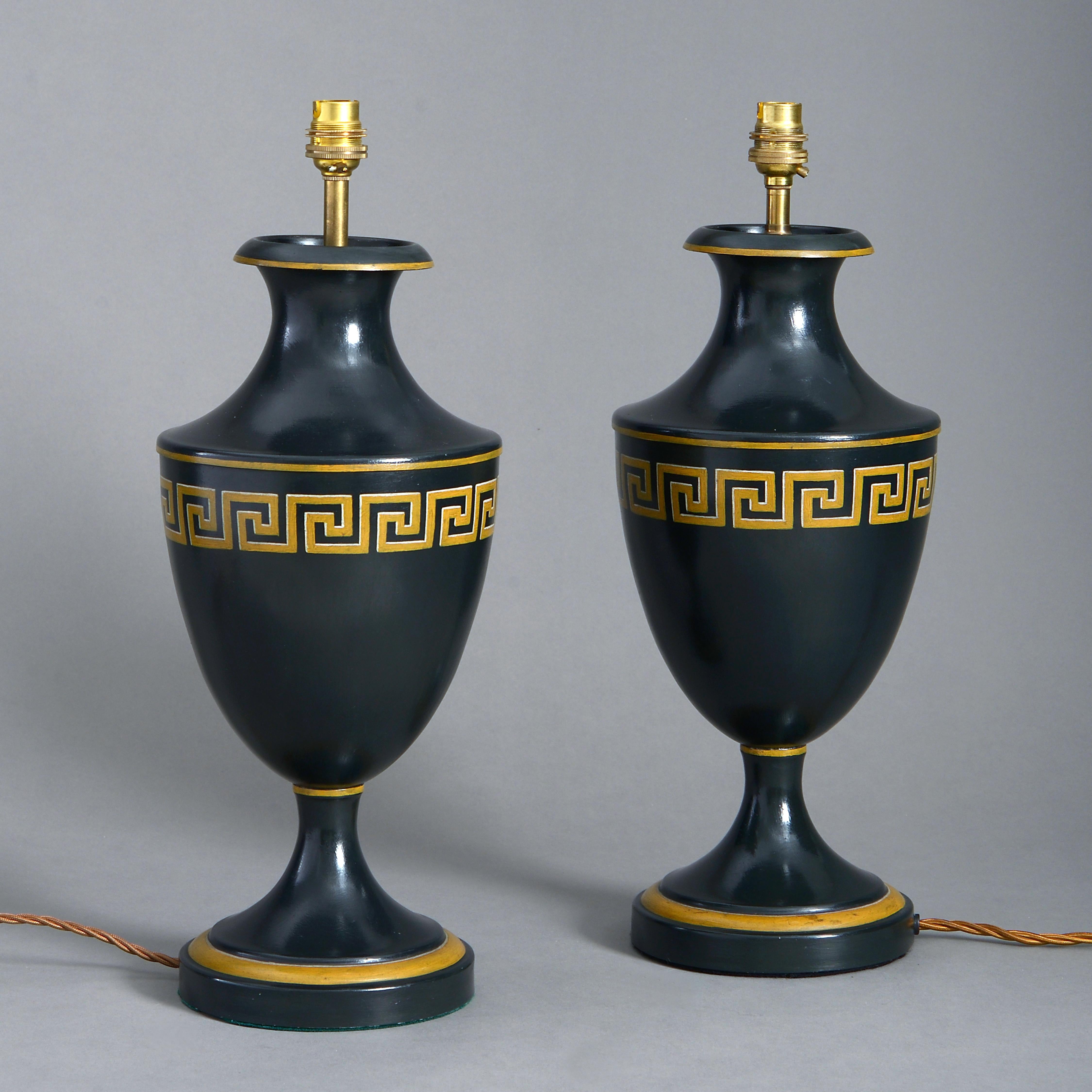 A pair of mid-20th century black painted tole vases of urn form, each decorated with banded Greek Key ornament.