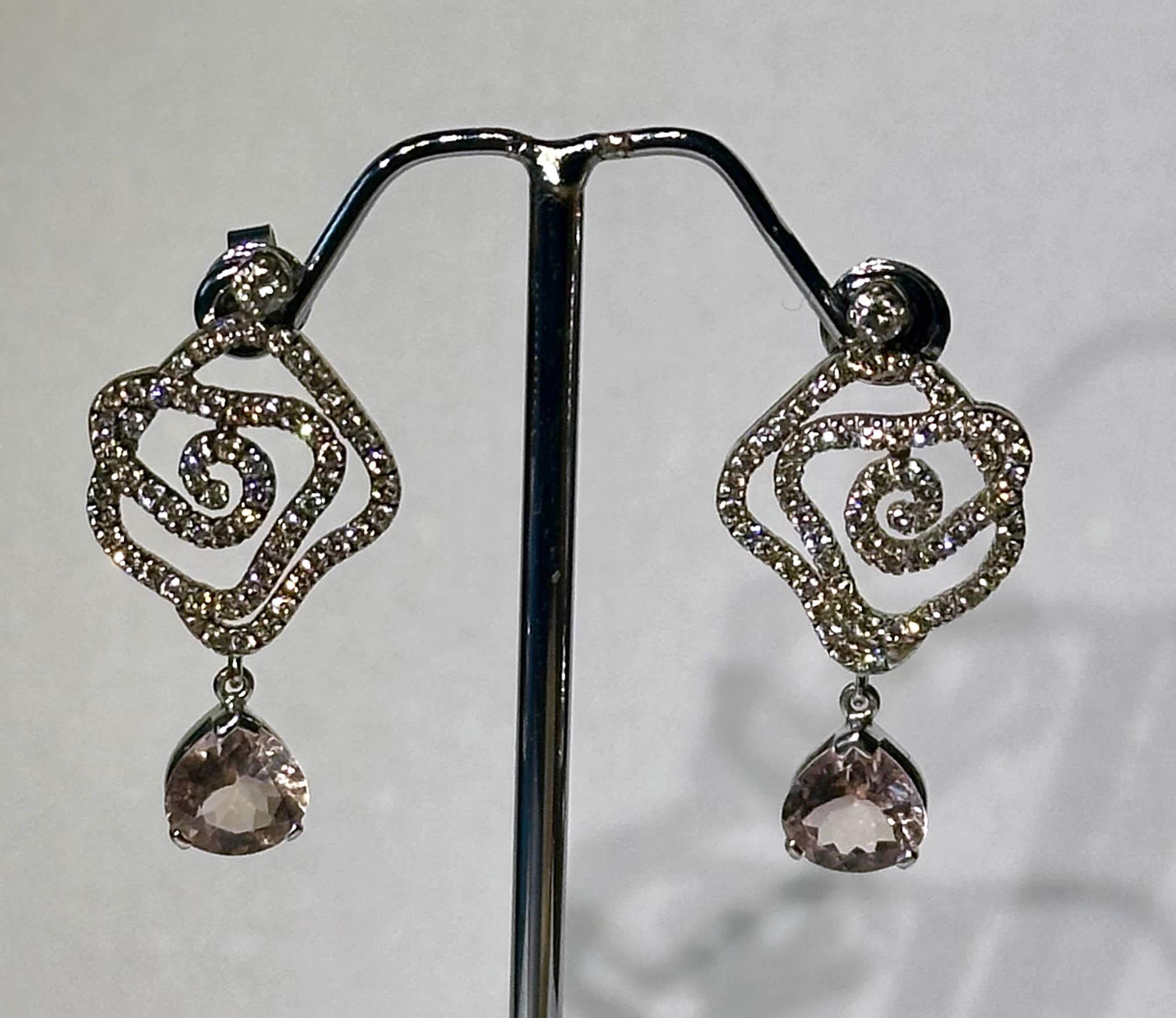 A Pair of Blackened 18kt White Gold Diamond Earrings with Morganite Dangles. 118 1mm round brilliant diamonds SI clarity K color. Two 2.5MM Round Brilliant SI clarity K color, and two Pear Cut Morganites that dangle from the bottom Total Diamond