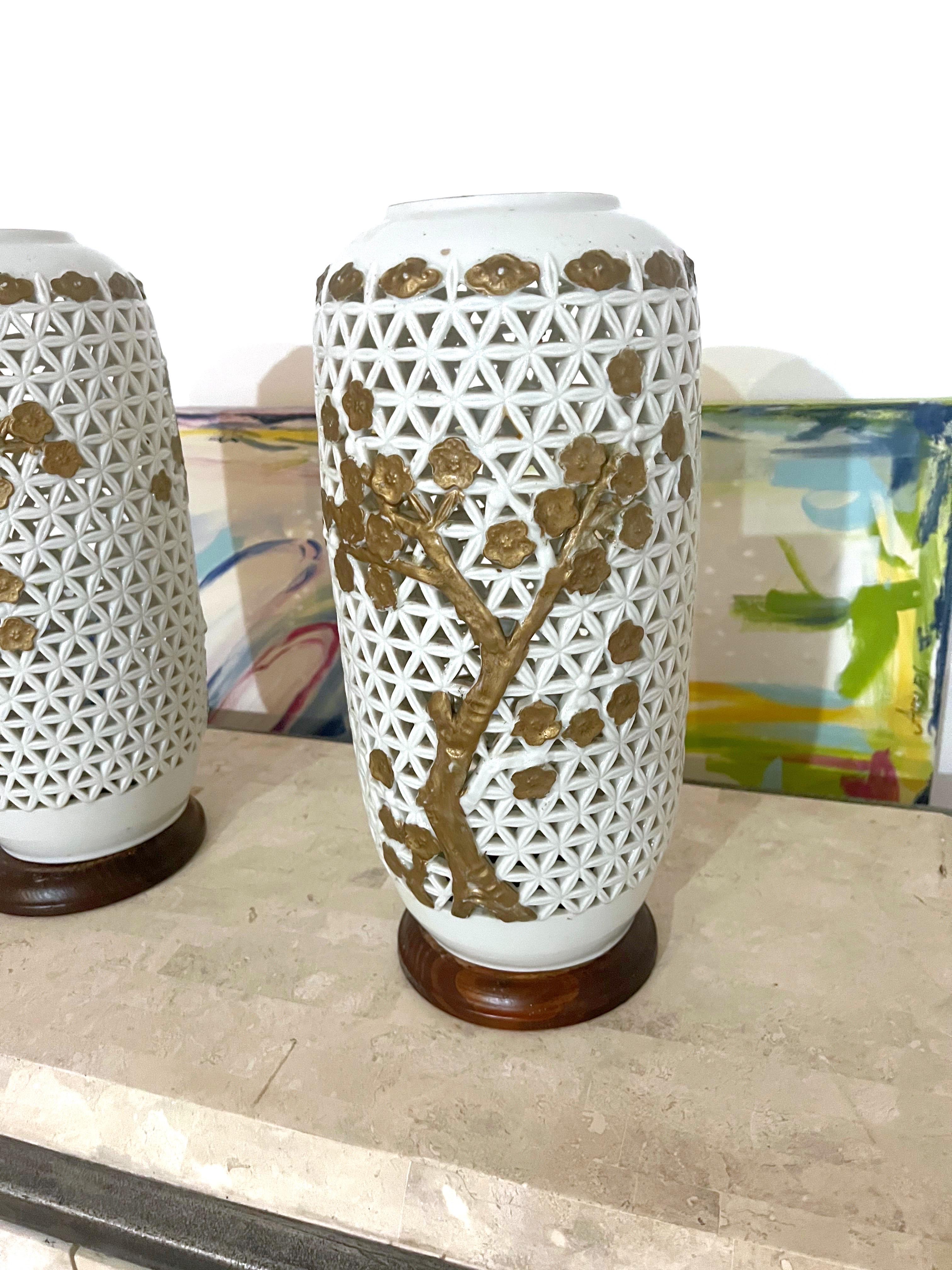 Antique pair of pierced Blanc de Chine Chinese porcelain vases formerly mounted as lamps. Each vase decorated with intricate ornate pierced pattern with central decorations of Chinese cherry blossom tree on each sides. Elegant craftsmanship during
