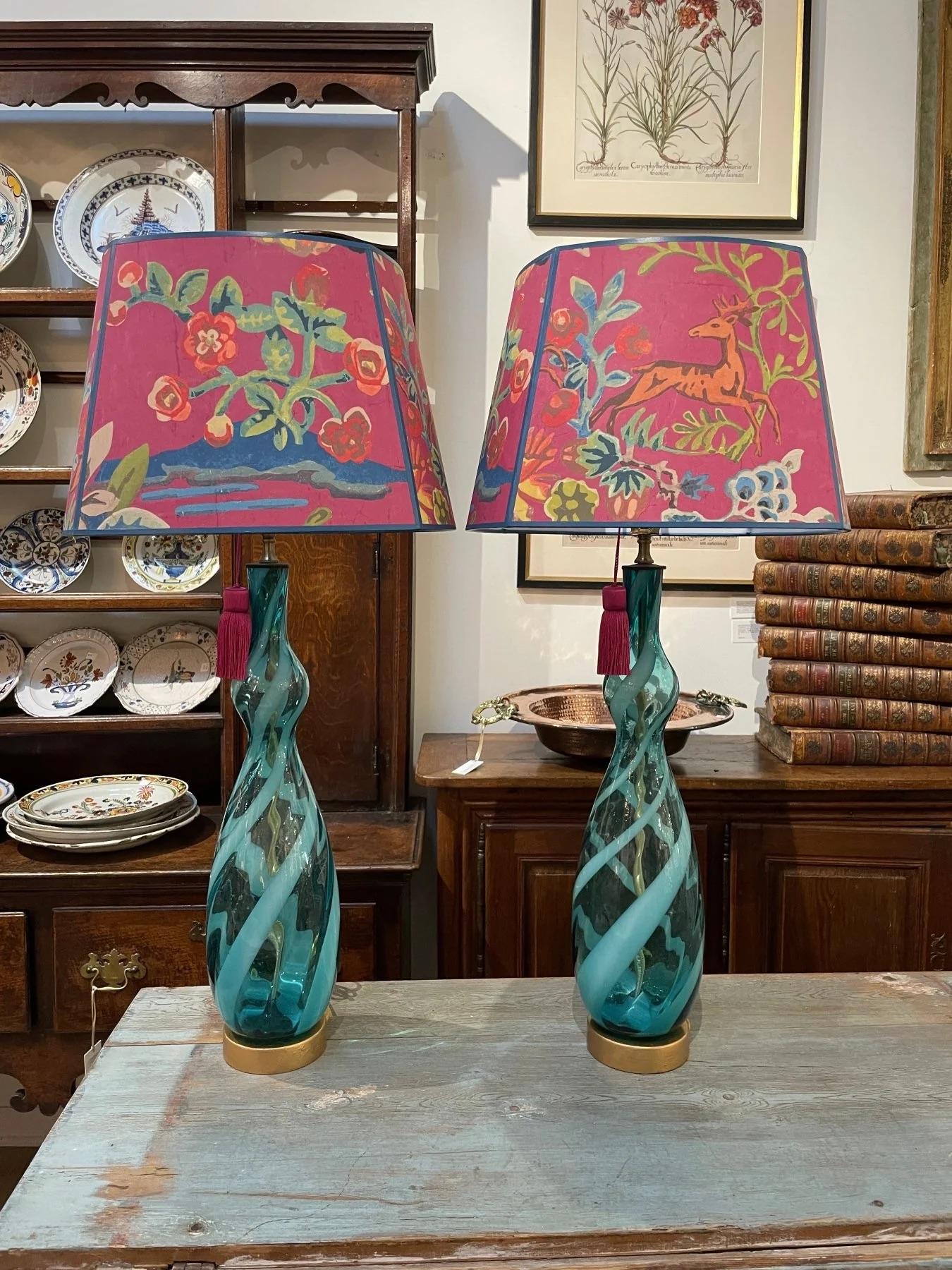 A pair of blue and clear twist Murano table lamps, c. 1960, having a latimo diagonal stripe. having brass bases. 34