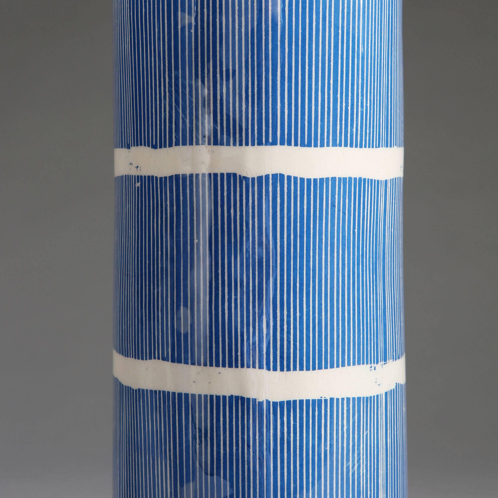 A pair of cylindrical Studio Pottery vases with blue and white striped decoration, now converted as lamps.

Please note: lampshades not included.