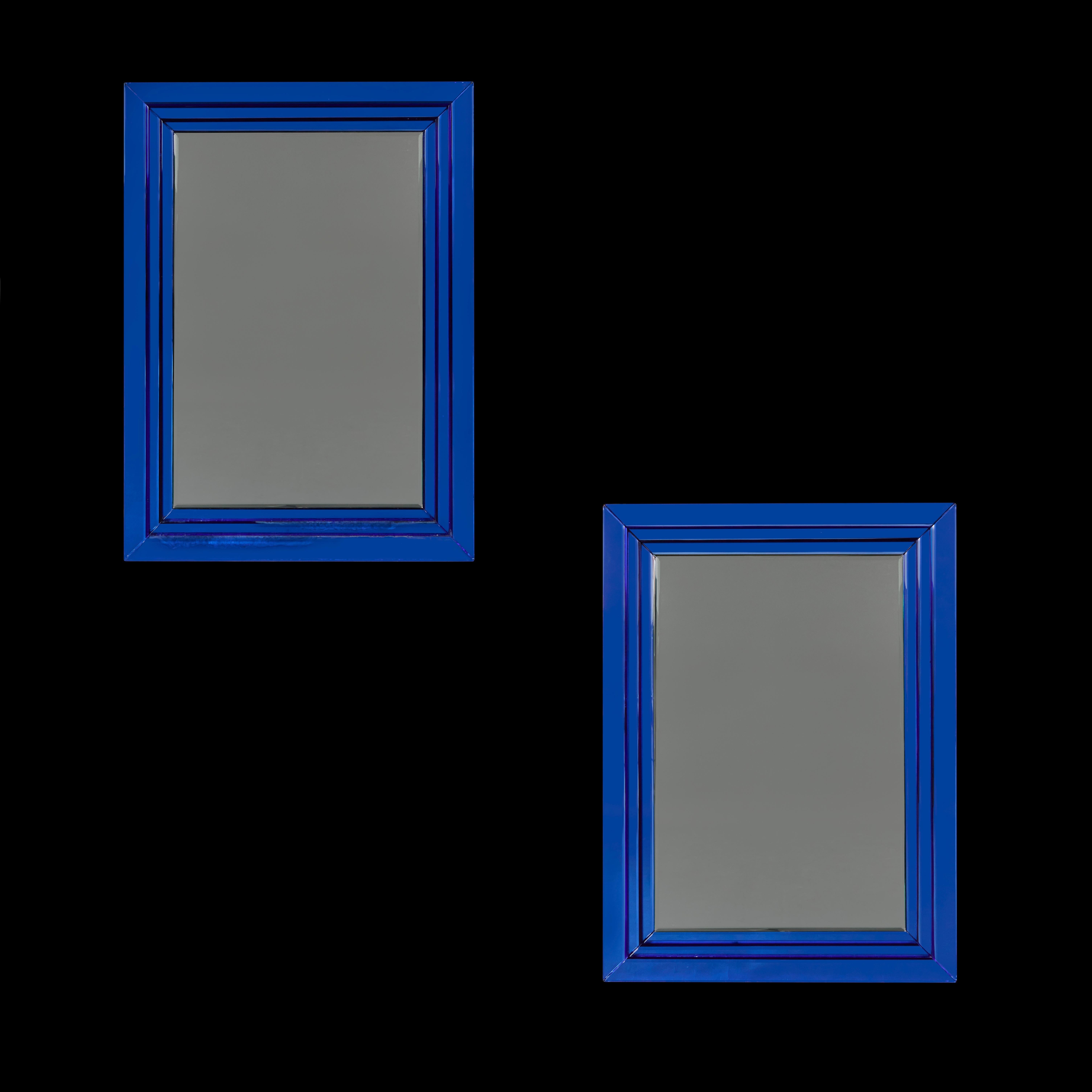 Paire de miroirs rectangulaires du milieu du XXe siècle, avec des bordures en verre bleu à gradins, la plaque centrale avec des bords biseautés. Après Arte Fontana. 