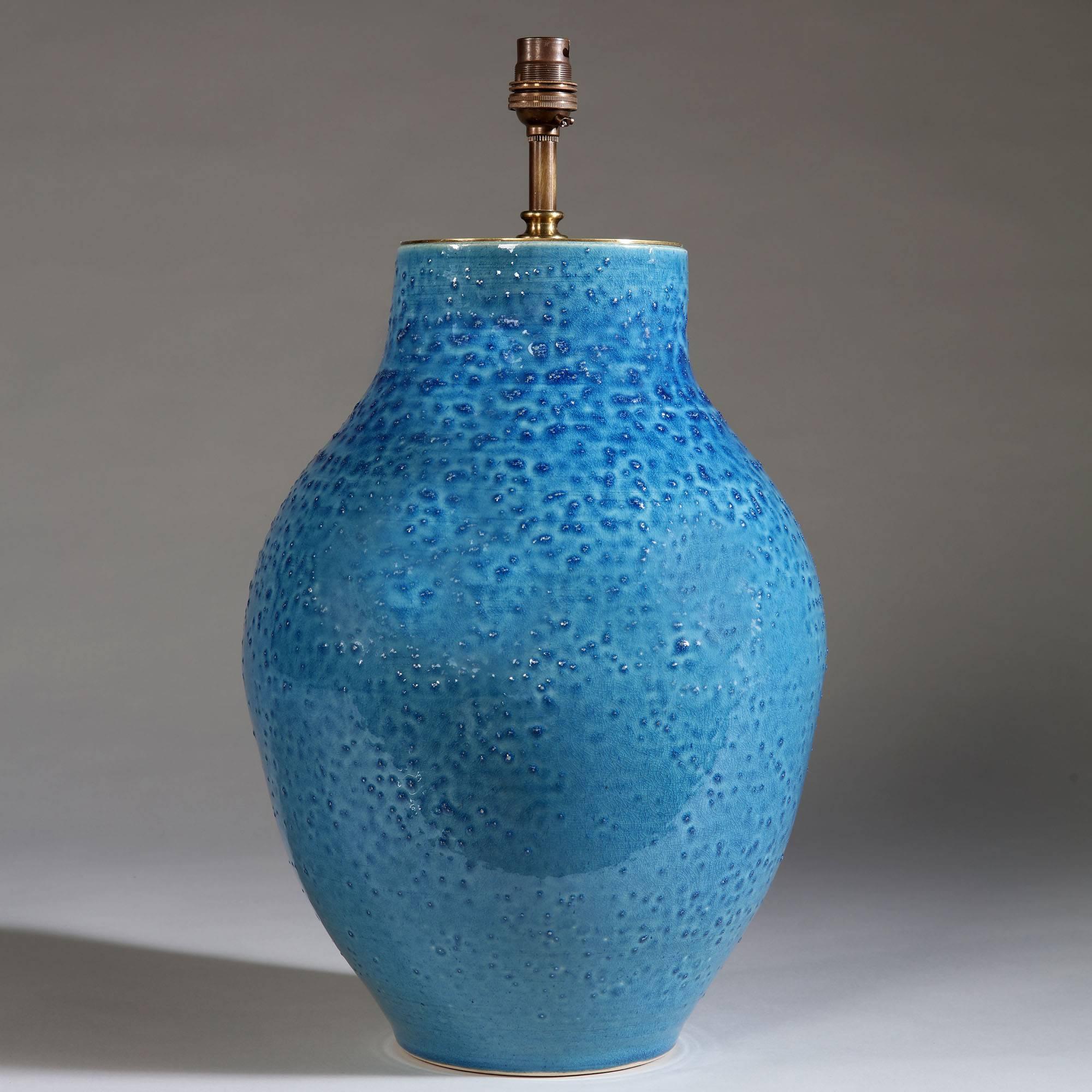 A large pair of ovoid form studio pottery vases with a blue bobble glaze, now converted as lamps.