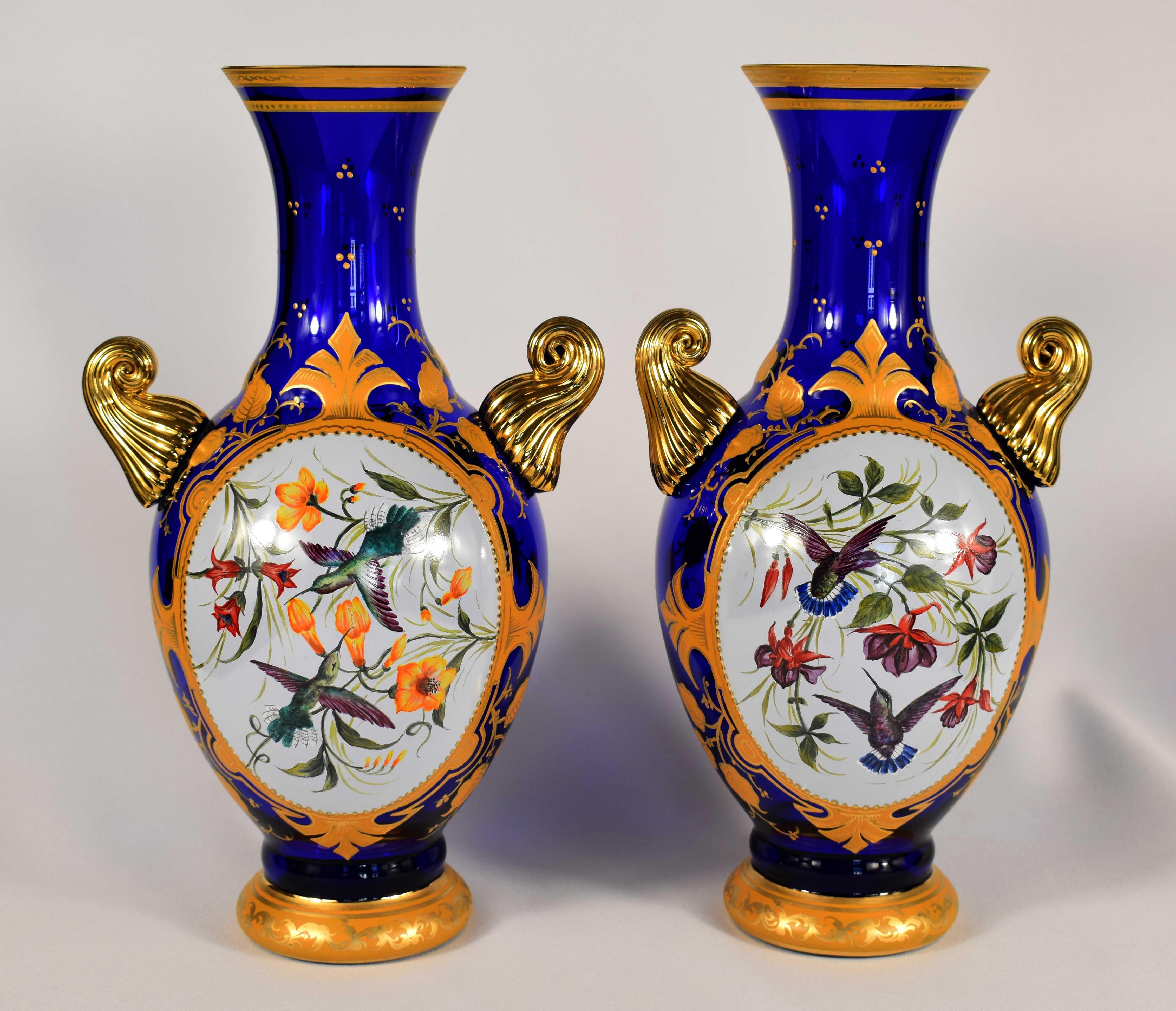 A beautiful pair of blue hand-painted vases with the motif of exotic birds, there is also a painted and gilded ornamental motif and leaves, everything is 100% handmade, They are made in antique style, This is Bohemian glass 20th century, It is an